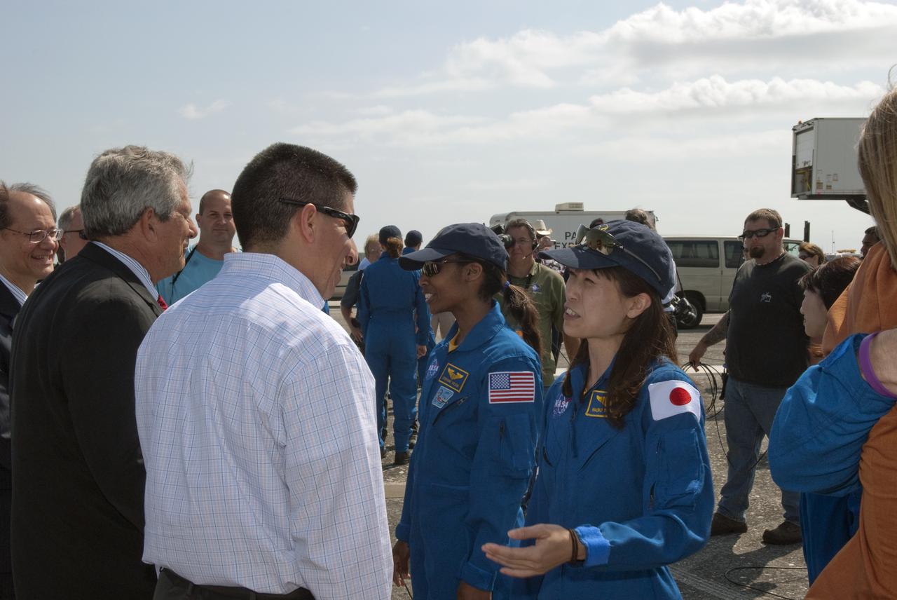 CAPE CANAVERAL, Fla. - At the Shuttle Landing Facility at NASA's Kennedy Space Center in Florida, NASA Flight Director Richard Jones from the Johnson Space Center talks to STS-131 Mission Specialist Naoko Yamazaki of the Japan Aerospace Exploration Agency, at right, about her successful mission following the landing of space shuttle Discovery on Runway 33.  On Jones' left, Larry Ostarly, director of Ground Systems Support, United Space Alliance, welcomes Mission Specialist Stephanie Wilson back from space.  Discovery landed at Kennedy after 15 days in space, completing the more than 6.2-million-mile STS-131 mission on orbit 238.  Main gear touchdown was at 9:08:35 a.m. EDT followed by nose gear touchdown at 9:08:47 a.m. and wheelstop at 9:09:33 a.m.  The seven-member STS-131 crew carried the multi-purpose logistics module Leonardo, filled with supplies, a new crew sleeping quarters and science racks that were transferred to the International Space Station's laboratories.  The crew also switched out a gyroscope on the station’s truss, installed a spare ammonia storage tank and retrieved a Japanese experiment from the station’s exterior.  STS-131 is the 33rd shuttle mission to the station and the 131st shuttle mission overall. For information on the STS-131 mission and crew, visit http:__www.nasa.gov_mission_pages_shuttle_shuttlemissions_sts131_index.html.  Photo credit: NASA_Jim Grossmann
