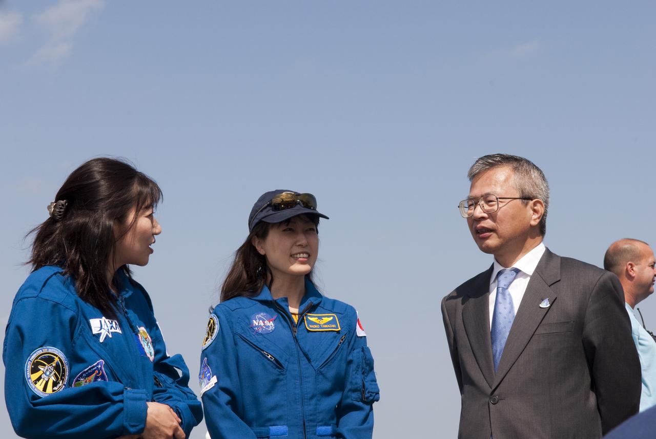 CAPE CANAVERAL, Fla. - At the Shuttle Landing Facility at NASA's Kennedy Space Center in Florida, Dr. Kuniaki Shiraki, right, executive director of the Japan Aerospace Exploration Agency, or JAXA, talks with STS-131 Mission Specialist and JAXA astronaut Naoko Yamazaki, center, following the landing of space shuttle Discovery on Runway 33. At left is STS-131 Flight Surgeon Dr. Akiko Matsumoto.  Discovery landed at Kennedy after 15 days in space, completing the more than 6.2-million-mile STS-131 mission on orbit 238.  Main gear touchdown was at 9:08:35 a.m. EDT followed by nose gear touchdown at 9:08:47 a.m. and wheelstop at 9:09:33 a.m.  The seven-member STS-131 crew carried the multi-purpose logistics module Leonardo, filled with supplies, a new crew sleeping quarters and science racks that were transferred to the International Space Station's laboratories.  The crew also switched out a gyroscope on the station’s truss, installed a spare ammonia storage tank and retrieved a Japanese experiment from the station’s exterior.  STS-131 is the 33rd shuttle mission to the station and the 131st shuttle mission overall. For information on the STS-131 mission and crew, visit http:__www.nasa.gov_mission_pages_shuttle_shuttlemissions_sts131_index.html.  Photo credit: NASA_Jim Grossmann
