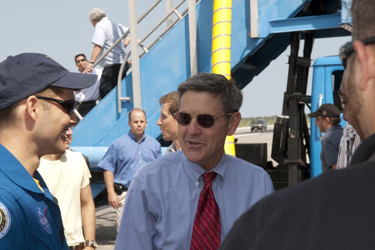 CAPE CANAVERAL, Fla. - At the Shuttle Landing Facility at NASA's Kennedy Space Center in Florida, STS-131 Pilot James P. Dutton Jr., left, and Kennedy Director Bob Cabana talk following space shuttle Discovery's landing.  Discovery landed on Runway 33 after 15 days in space, completing the more than 6.2-million-mile STS-131 mission on orbit 238.  Main gear touchdown was at 9:08:35 a.m. EDT followed by nose gear touchdown at 9:08:47 a.m. and wheelstop at 9:09:33 a.m.  The seven-member STS-131 crew carried the multi-purpose logistics module Leonardo, filled with supplies, a new crew sleeping quarters and science racks that were transferred to the International Space Station's laboratories.  The crew also switched out a gyroscope on the station’s truss, installed a spare ammonia storage tank and retrieved a Japanese experiment from the station’s exterior.  STS-131 is the 33rd shuttle mission to the station and the 131st shuttle mission overall. For information on the STS-131 mission and crew, visit http:__www.nasa.gov_mission_pages_shuttle_shuttlemissions_sts131_index.html.  Photo credit: NASA_Jim Grossmann
