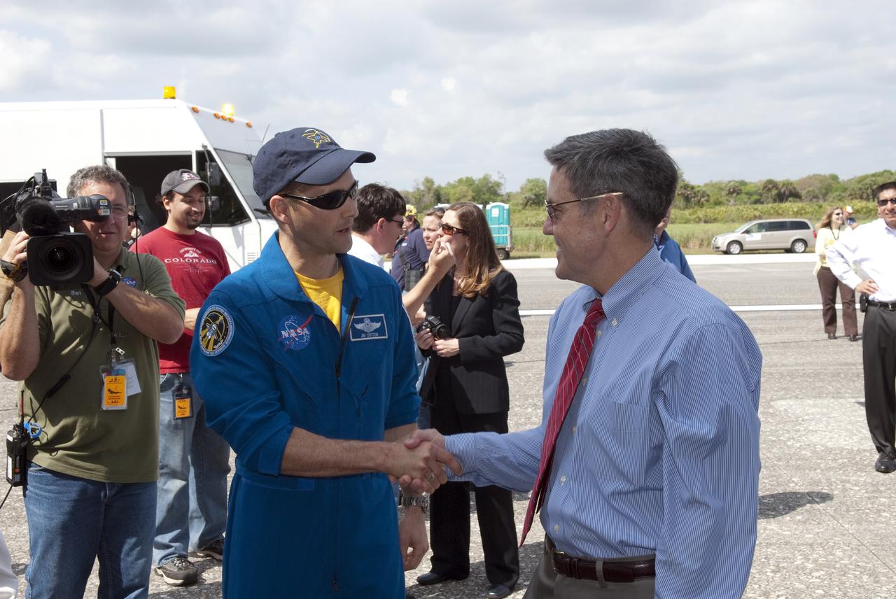 CAPE CANAVERAL, Fla. - At the Shuttle Landing Facility at NASA's Kennedy Space Center in Florida, Kennedy Director Bob Cabana, right, congratulates STS-131 Pilot James P. Dutton Jr. on his successful mission following the landing of space shuttle Discovery.  Discovery landed on Runway 33 after 15 days in space, completing the more than 6.2-million-mile STS-131 mission on orbit 238.  Main gear touchdown was at 9:08:35 a.m. EDT followed by nose gear touchdown at 9:08:47 a.m. and wheelstop at 9:09:33 a.m.  The seven-member STS-131 crew carried the multi-purpose logistics module Leonardo, filled with supplies, a new crew sleeping quarters and science racks that were transferred to the International Space Station's laboratories.  The crew also switched out a gyroscope on the station’s truss, installed a spare ammonia storage tank and retrieved a Japanese experiment from the station’s exterior.  STS-131 is the 33rd shuttle mission to the station and the 131st shuttle mission overall. For information on the STS-131 mission and crew, visit http:__www.nasa.gov_mission_pages_shuttle_shuttlemissions_sts131_index.html.  Photo credit: NASA_Jim Grossmann