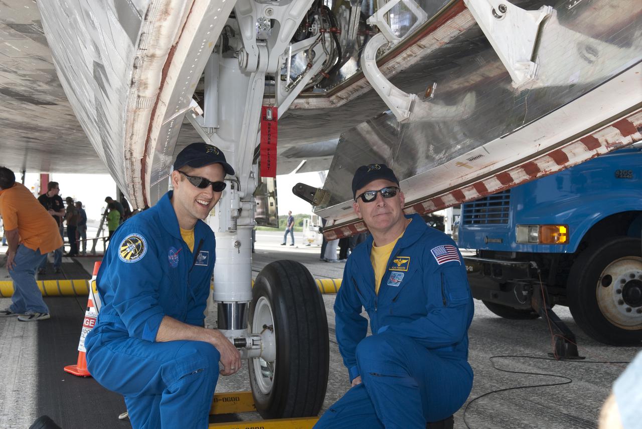 CAPE CANAVERAL, Fla. - At the Shuttle Landing Facility at NASA's Kennedy Space Center in Florida, STS-131 Pilot James P. Dutton Jr., left, and Commander Alan Poindexter proudly pose for the camera under space shuttle Discovery.  Discovery landed on Runway 33 after 15 days in space, completing the more than 6.2-million-mile STS-131 mission on orbit 238.  Main gear touchdown was at 9:08:35 a.m. EDT followed by nose gear touchdown at 9:08:47 a.m. and wheelstop at 9:09:33 a.m.  The seven-member STS-131 crew carried the multi-purpose logistics module Leonardo, filled with supplies, a new crew sleeping quarters and science racks that were transferred to the International Space Station's laboratories.  The crew also switched out a gyroscope on the station’s truss, installed a spare ammonia storage tank and retrieved a Japanese experiment from the station’s exterior.  STS-131 is the 33rd shuttle mission to the station and the 131st shuttle mission overall. For information on the STS-131 mission and crew, visit http:__www.nasa.gov_mission_pages_shuttle_shuttlemissions_sts131_index.html.  Photo credit: NASA_Jim Grossmann