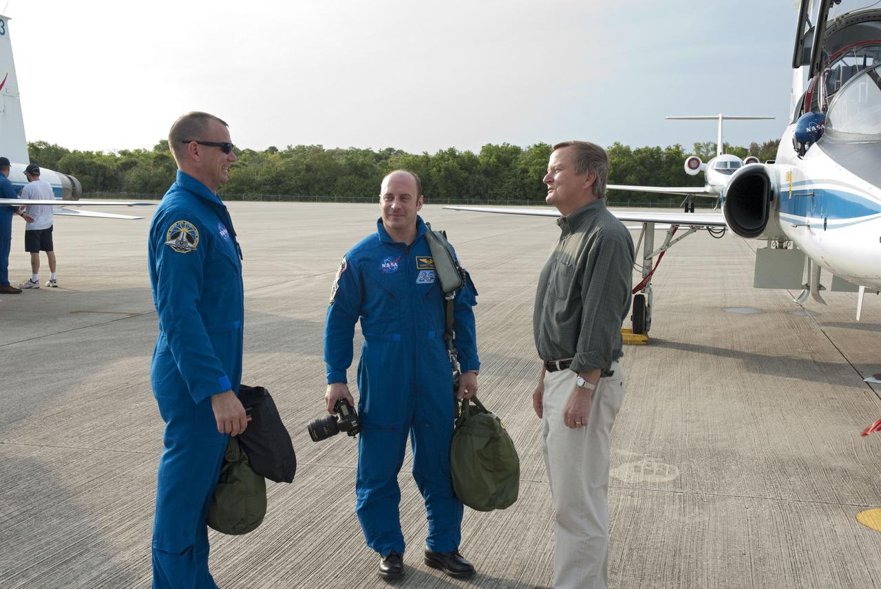CAPE CANAVERAL, Fla. - Space Shuttle Launch Director Mike Leinbach, right, welcomes STS-132 Pilot Tony Antonelli, left, and Mission Specialist Garrett Reisman to NASA's Kennedy Space Center in Florida for a practice launch dress rehearsal called the Terminal Countdown Demonstration Test, or TCDT. The STS-132 crew arrived at Kennedy’s Shuttle Landing Facility at 6:11 p.m. EDT aboard four T-38 jets. TCDT provides each shuttle crew and launch team with an opportunity to participate in various simulated countdown activities, including equipment familiarization and emergency training. On the STS-132 mission, the six-member crew will deliver an Integrated Cargo Carrier, or ICC, and the Russian-built Mini-Research Module-1, or MRM-1, to the International Space Station aboard space shuttle Atlantis. The ICC is an unpressurized flat bed pallet and keel yoke assembly used to support the transfer of exterior cargo from the shuttle to the space station. The MRM-1, known as Rassvet, is the second in a series of new pressurized components for Russia and will be permanently attached to the Earth-facing port of the Zarya control module. Rassvet, which translates to 'dawn,' will be used for cargo storage and will provide an additional docking port to the station. STS-132 is the 34th mission to the station and the 132nd shuttle mission overall. Atlantis is targeted to launch on May 14 at 2:19 p.m. For information on the STS-132 mission, visit http:__www.nasa.gov_mission_pages_shuttle_shuttlemissions_sts132_index.html. Photo credit: NASA_Cory Huston