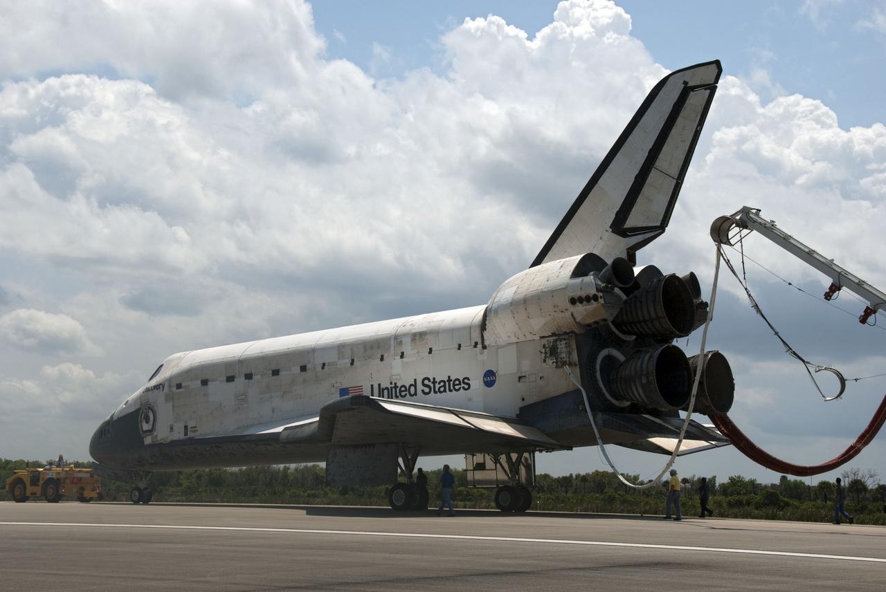 CAPE CANAVERAL, Fla. - At NASA's Kennedy Space Center in Florida, space shuttle Discovery begins its slow trek from the Shuttle Landing Facility to Orbiter Processing Facility-3 following its successful landing on Runway 33.  Discovery landed at Kennedy after 15 days in space, completing the more than 6.2-million-mile STS-131 mission on orbit 238.  Main gear touchdown was at 9:08:35 a.m. EDT followed by nose gear touchdown at 9:08:47 a.m. and wheelstop at 9:09:33 a.m.  Aboard were Commander Alan Poindexter; Pilot James P. Dutton Jr.; and Mission Specialists Rick Mastracchio, Clayton Anderson, Dorothy Metcalf-Lindenburger, Stephanie Wilson and Naoko Yamazaki of the Japan Aerospace Exploration Agency.  The seven-member STS-131 crew carried the multi-purpose logistics module Leonardo, filled with supplies, a new crew sleeping quarters and science racks that were transferred to the International Space Station's laboratories.  The crew also switched out a gyroscope on the station’s truss, installed a spare ammonia storage tank and retrieved a Japanese experiment from the station’s exterior.  STS-131 is the 33rd shuttle mission to the station and the 131st shuttle mission overall. For information on the STS-131 mission and crew, visit http:__www.nasa.gov_mission_pages_shuttle_shuttlemissions_sts131_index.html.  Photo credit: NASA_Jim Grossmann
