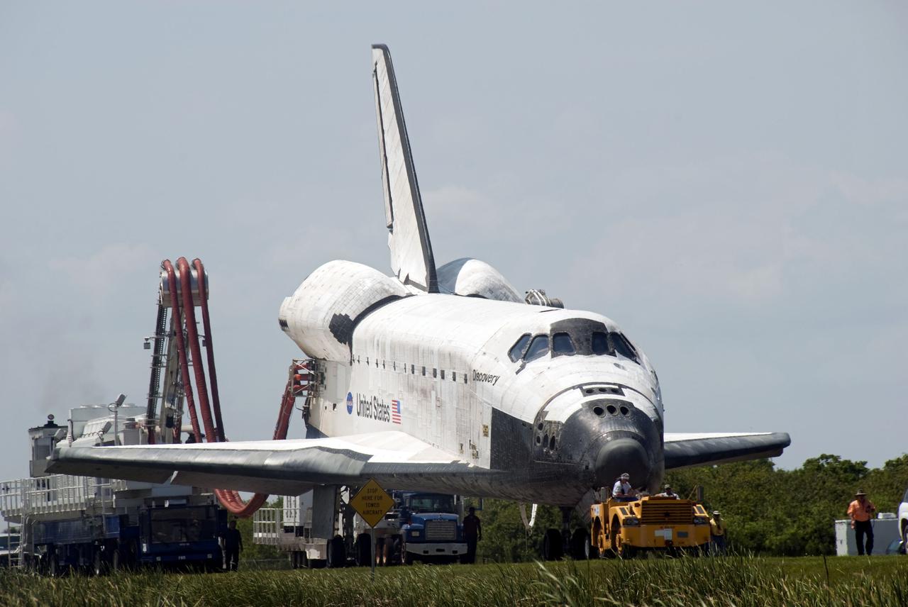 CAPE CANAVERAL, Fla. - At NASA's Kennedy Space Center in Florida, space shuttle Discovery makes its slow trek from the Shuttle Landing Facility to Orbiter Processing Facility-3 following its successful landing on Runway 33.  Discovery landed at Kennedy after 15 days in space, completing the more than 6.2-million-mile STS-131 mission on orbit 238.  Main gear touchdown was at 9:08:35 a.m. EDT followed by nose gear touchdown at 9:08:47 a.m. and wheelstop at 9:09:33 a.m.  Aboard were Commander Alan Poindexter; Pilot James P. Dutton Jr.; and Mission Specialists Rick Mastracchio, Clayton Anderson, Dorothy Metcalf-Lindenburger, Stephanie Wilson and Naoko Yamazaki of the Japan Aerospace Exploration Agency.  The seven-member STS-131 crew carried the multi-purpose logistics module Leonardo, filled with supplies, a new crew sleeping quarters and science racks that were transferred to the International Space Station's laboratories.  The crew also switched out a gyroscope on the station’s truss, installed a spare ammonia storage tank and retrieved a Japanese experiment from the station’s exterior.  STS-131 is the 33rd shuttle mission to the station and the 131st shuttle mission overall. For information on the STS-131 mission and crew, visit http:__www.nasa.gov_mission_pages_shuttle_shuttlemissions_sts131_index.html.  Photo credit: NASA_Jim Grossmann