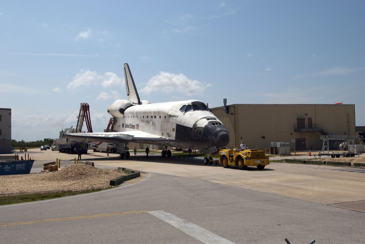 CAPE CANAVERAL, Fla. - At NASA's Kennedy Space Center in Florida, space shuttle Discovery approaches Orbiter Processing Facility-3 following its successful landing on Runway 33 at the Shuttle Landing Facility.  Discovery landed at Kennedy after 15 days in space, completing the more than 6.2-million-mile STS-131 mission on orbit 238.  Main gear touchdown was at 9:08:35 a.m. EDT followed by nose gear touchdown at 9:08:47 a.m. and wheelstop at 9:09:33 a.m.  Aboard were Commander Alan Poindexter; Pilot James P. Dutton Jr.; and Mission Specialists Rick Mastracchio, Clayton Anderson, Dorothy Metcalf-Lindenburger, Stephanie Wilson and Naoko Yamazaki of the Japan Aerospace Exploration Agency.  The seven-member STS-131 crew carried the multi-purpose logistics module Leonardo, filled with supplies, a new crew sleeping quarters and science racks that were transferred to the International Space Station's laboratories.  The crew also switched out a gyroscope on the station’s truss, installed a spare ammonia storage tank and retrieved a Japanese experiment from the station’s exterior.  STS-131 is the 33rd shuttle mission to the station and the 131st shuttle mission overall. For information on the STS-131 mission and crew, visit http:__www.nasa.gov_mission_pages_shuttle_shuttlemissions_sts131_index.html.  Photo credit: NASA_Jim Grossmann