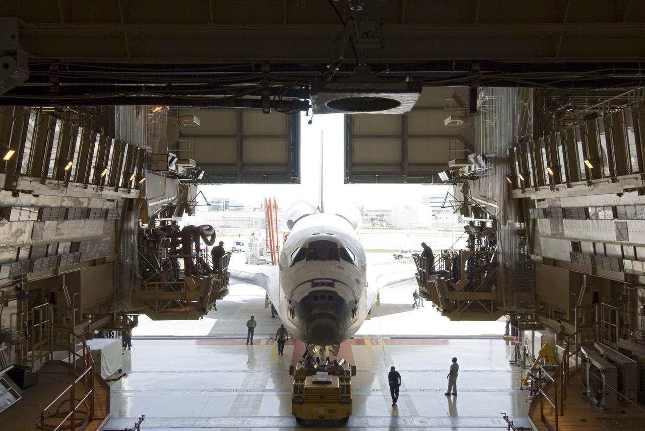 CAPE CANAVERAL, Fla. - At NASA's Kennedy Space Center in Florida, space shuttle Discovery is towed into Orbiter Processing Facility-3 following its successful landing on Runway 33 at the Shuttle Landing Facility.  Discovery landed at Kennedy after 15 days in space, completing the more than 6.2-million-mile STS-131 mission on orbit 238.  Main gear touchdown was at 9:08:35 a.m. EDT followed by nose gear touchdown at 9:08:47 a.m. and wheelstop at 9:09:33 a.m.  Aboard were Commander Alan Poindexter; Pilot James P. Dutton Jr.; and Mission Specialists Rick Mastracchio, Clayton Anderson, Dorothy Metcalf-Lindenburger, Stephanie Wilson and Naoko Yamazaki of the Japan Aerospace Exploration Agency.  The seven-member STS-131 crew carried the multi-purpose logistics module Leonardo, filled with supplies, a new crew sleeping quarters and science racks that were transferred to the International Space Station's laboratories.  The crew also switched out a gyroscope on the station’s truss, installed a spare ammonia storage tank and retrieved a Japanese experiment from the station’s exterior.  STS-131 is the 33rd shuttle mission to the station and the 131st shuttle mission overall. For information on the STS-131 mission and crew, visit http:__www.nasa.gov_mission_pages_shuttle_shuttlemissions_sts131_index.html.  Photo credit: NASA_Jim Grossmann