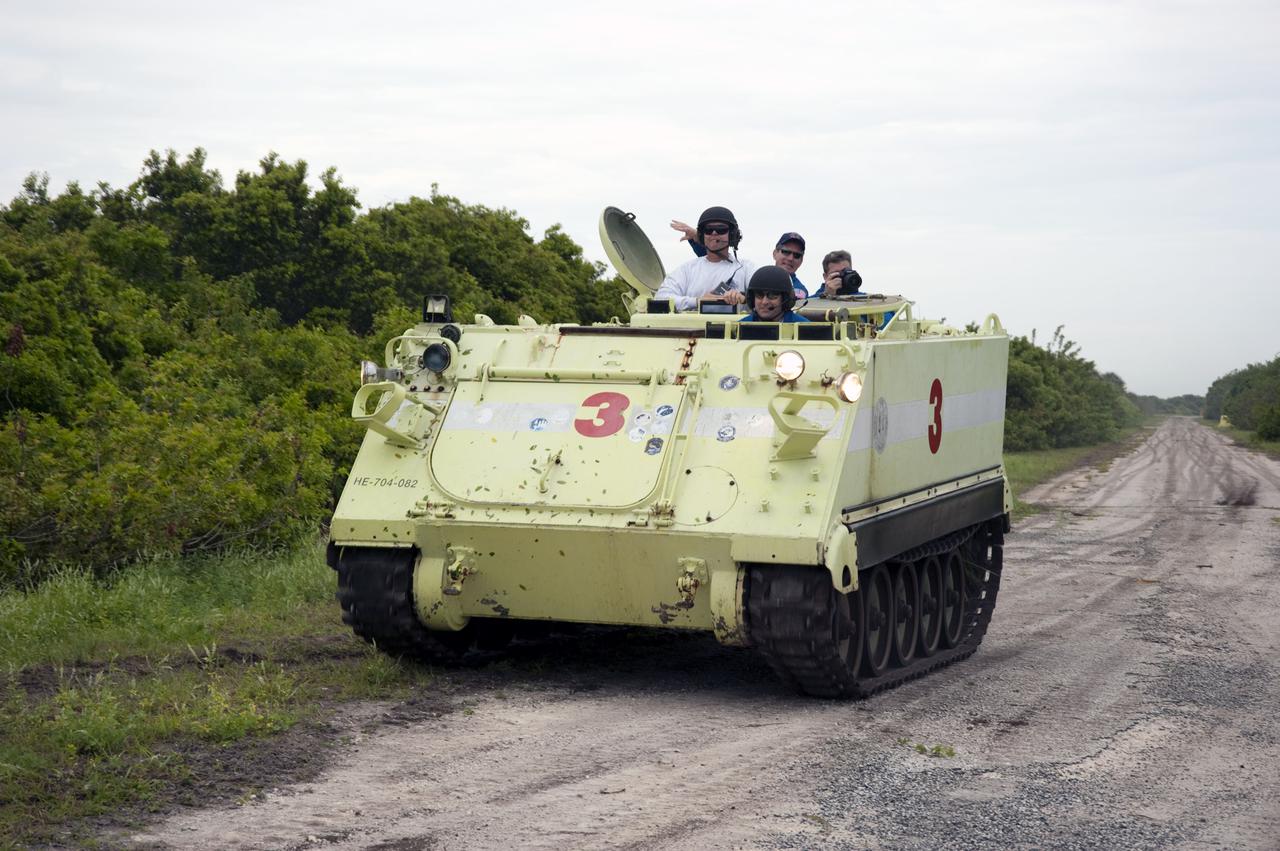 CAPE CANAVERAL, Fla. - At NASA's Kennedy Space Center in Florida, STS-132 Commander Ken Ham takes his instructor, Battalion Chief David Seymour, at left, for a ride in an M-113 armored personnel carrier during driving practice.  Also along for the ride is Mission Specialist Michael Good.  An M-113 is kept at the foot of the launch pad in case an emergency egress from the vicinity of the pad is needed.  The STS-132 crew is participating in their Terminal Countdown Demonstration Test, or TCDT, a dress rehearsal for launch.  TCDT provides each shuttle crew and launch team the opportunity to participate in various simulated countdown activities, including equipment familiarization and emergency training.  On the STS-132 mission, the six-member crew will deliver an Integrated Cargo Carrier, or ICC, and the Russian-built Mini-Research Module-1, or MRM-1, to the International Space Station aboard space shuttle Atlantis.  The ICC is an unpressurized flat bed pallet and keel yoke assembly used to support the transfer of exterior cargo from the shuttle to the space station.  The MRM-1, known as Rassvet, is the second in a series of new pressurized components for Russia and will be permanently attached to the Earth-facing port of the Zarya control module. Rassvet, which translates to 'dawn,' will be used for cargo storage and will provide an additional docking port to the station.  STS-132 is the 34th mission to the station and the 132nd shuttle mission overall.   Atlantis is targeted to launch on May 14 at 2:19 p.m.  For information on the STS-132 mission, visit http:__www.nasa.gov_mission_pages_shuttle_shuttlemissions_sts132_index.html. Photo credit: NASA_Kim Shiflett