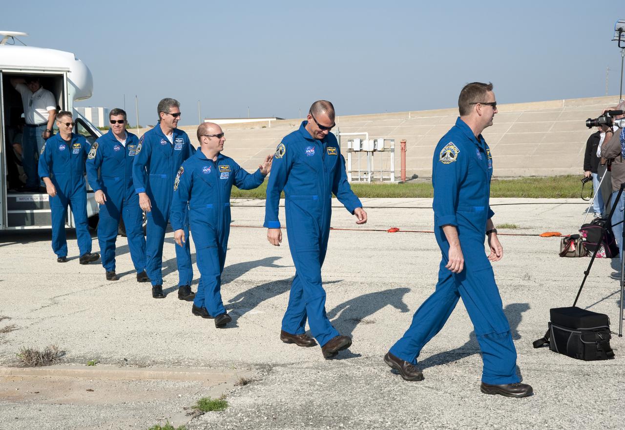 CAPE CANAVERAL, Fla. - At NASA's Kennedy Space Center in Florida, the crew of space shuttle Atlantis' STS-132 mission take time out from their training to participate in a question-and-answer session with media representatives at Launch Pad 39A. From left are Mission Specialists Piers Sellers, Steve Bowen, Michael Good and Garrett Reisman; Pilot Tony Antonelli; and Commander Ken Ham. The crew is at Kennedy for their Terminal Countdown Demonstration Test, or TCDT, a dress rehearsal for launch. TCDT provides each shuttle crew and launch team the opportunity to participate in various simulated countdown activities, including equipment familiarization and emergency training. On the STS-132 mission, the six-member crew will deliver an Integrated Cargo Carrier, or ICC, and the Russian-built Mini-Research Module-1, or MRM-1, to the International Space Station aboard space shuttle Atlantis. The ICC is an unpressurized flat bed pallet and keel yoke assembly used to support the transfer of exterior cargo from the shuttle to the space station. The MRM-1, known as Rassvet, is the second in a series of new pressurized components for Russia and will be permanently attached to the Earth-facing port of the Zarya control module. Rassvet, which translates to 'dawn,' will be used for cargo storage and will provide an additional docking port to the station. STS-132 is the 34th mission to the station and the 132nd shuttle mission overall. Atlantis is targeted to launch on May 14 at 2:19 p.m. For information on the STS-132 mission, visit http:__www.nasa.gov_mission_pages_shuttle_shuttlemissions_sts132_index.html. Photo credit: NASA_Kim Shiflett