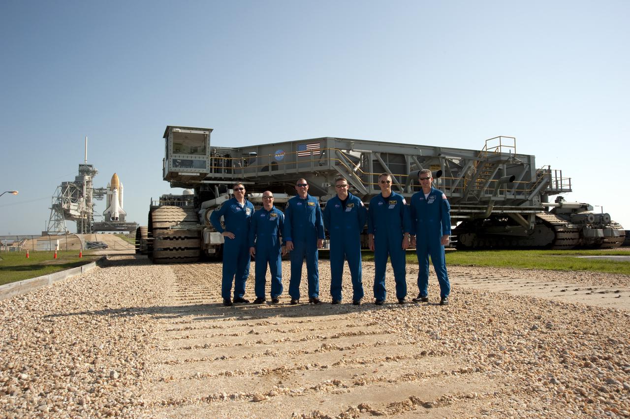 CAPE CANAVERAL, Fla. - At Launch Pad 39A at NASA's Kennedy Space Center in Florida, the STS-132 crew poses for a group portrait in front of the crawler-transporter that delivered space shuttle Atlantis to the pad earlier in the morning. From left are Mission Specialists Steve Bowen and Garrett Reisman; Pilot Tony Antonelli; Commander Ken Ham; and Mission Specialists Piers Sellers and Michael Good. The crew is at Kennedy for their Terminal Countdown Demonstration Test, or TCDT, a dress rehearsal for launch. TCDT provides each shuttle crew and launch team the opportunity to participate in various simulated countdown activities, including equipment familiarization and emergency training. On the STS-132 mission, the six-member crew will deliver an Integrated Cargo Carrier, or ICC, and the Russian-built Mini-Research Module-1, or MRM-1, to the International Space Station aboard space shuttle Atlantis. The ICC is an unpressurized flat bed pallet and keel yoke assembly used to support the transfer of exterior cargo from the shuttle to the space station. The MRM-1, known as Rassvet, is the second in a series of new pressurized components for Russia and will be permanently attached to the Earth-facing port of the Zarya control module. Rassvet, which translates to 'dawn,' will be used for cargo storage and will provide an additional docking port to the station. STS-132 is the 34th mission to the station and the 132nd shuttle mission overall. Atlantis is targeted to launch on May 14 at 2:19 p.m. For information on the STS-132 mission, visit http:__www.nasa.gov_mission_pages_shuttle_shuttlemissions_sts132_index.html. Photo credit: NASA_Kim Shiflett