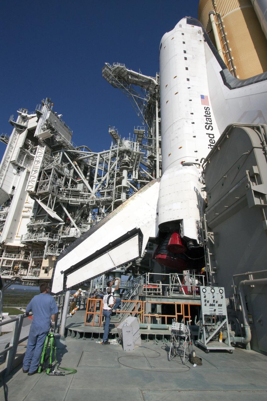 CAPE CANAVERAL, Fla. – On Launch Pad 39A at NASA's Kennedy Space Center in Florida, space shuttle Atlantis, attached to its external fuel tank and solid rocket boosters, towers above the workers on the surface of the mobile launcher platform on which it is secured.  From the top of the platform to the tip of the tank is approximately 184 feet.  Atlantis' first motion on its 3.4-mile trip from the Vehicle Assembly Building was at 11:31 p.m. EDT April 21.  The shuttle was secured, or 'hard down,' on the pad at 6:03 a.m. April 22.  Rollout is a significant milestone in launch processing activities.  On the STS-132 mission, the six-member crew will deliver an Integrated Cargo Carrier, or ICC, and the Russian-built Mini-Research Module-1, or MRM-1, to the International Space Station.  The ICC is an unpressurized flat bed pallet and keel yoke assembly used to support the transfer of exterior cargo from the shuttle to the space station.  The MRM-1, known as Rassvet, is the second in a series of new pressurized components for Russia and will be permanently attached to the Earth-facing port of the Zarya control module. Rassvet, which translates to 'dawn,' will be used for cargo storage and will provide an additional docking port to the station.  STS-132 is the 34th mission to the station and the 132nd shuttle mission overall.   Atlantis is targeted to launch on May 14 at 2:19 p.m.  For information on the STS-132 mission, visit http:__www.nasa.gov_mission_pages_shuttle_shuttlemissions_sts132_index.html. Photo credit: NASA_Jack Pfaller