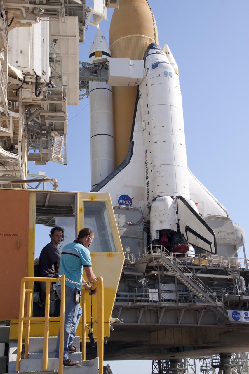 CAPE CANAVERAL, Fla. – On Launch Pad 39A at NASA's Kennedy Space Center in Florida, United Space Alliance workers in the cab of the rotating service structure prepare to close it around space shuttle Atlantis.  This mobile structure provides protected access to the shuttle for installation and servicing of payloads at the pad, as well as servicing access to certain systems on the shuttle.  Atlantis' first motion on its 3.4-mile trip from the Vehicle Assembly Building was at 11:31 p.m. EDT April 21.  The shuttle was secured, or 'hard down,' on the pad at 6:03 a.m. April 22.  Rollout is a significant milestone in launch processing activities.  On the STS-132 mission, the six-member crew will deliver an Integrated Cargo Carrier, or ICC, and the Russian-built Mini-Research Module-1, or MRM-1, to the International Space Station.  The ICC is an unpressurized flat bed pallet and keel yoke assembly used to support the transfer of exterior cargo from the shuttle to the space station.  The MRM-1, known as Rassvet, is the second in a series of new pressurized components for Russia and will be permanently attached to the Earth-facing port of the Zarya control module. Rassvet, which translates to 'dawn,' will be used for cargo storage and will provide an additional docking port to the station.  STS-132 is the 34th mission to the station and the 132nd shuttle mission overall.   Atlantis is targeted to launch on May 14 at 2:19 p.m.  For information on the STS-132 mission, visit http:__www.nasa.gov_mission_pages_shuttle_shuttlemissions_sts132_index.html. Photo credit: NASA_Jack Pfaller