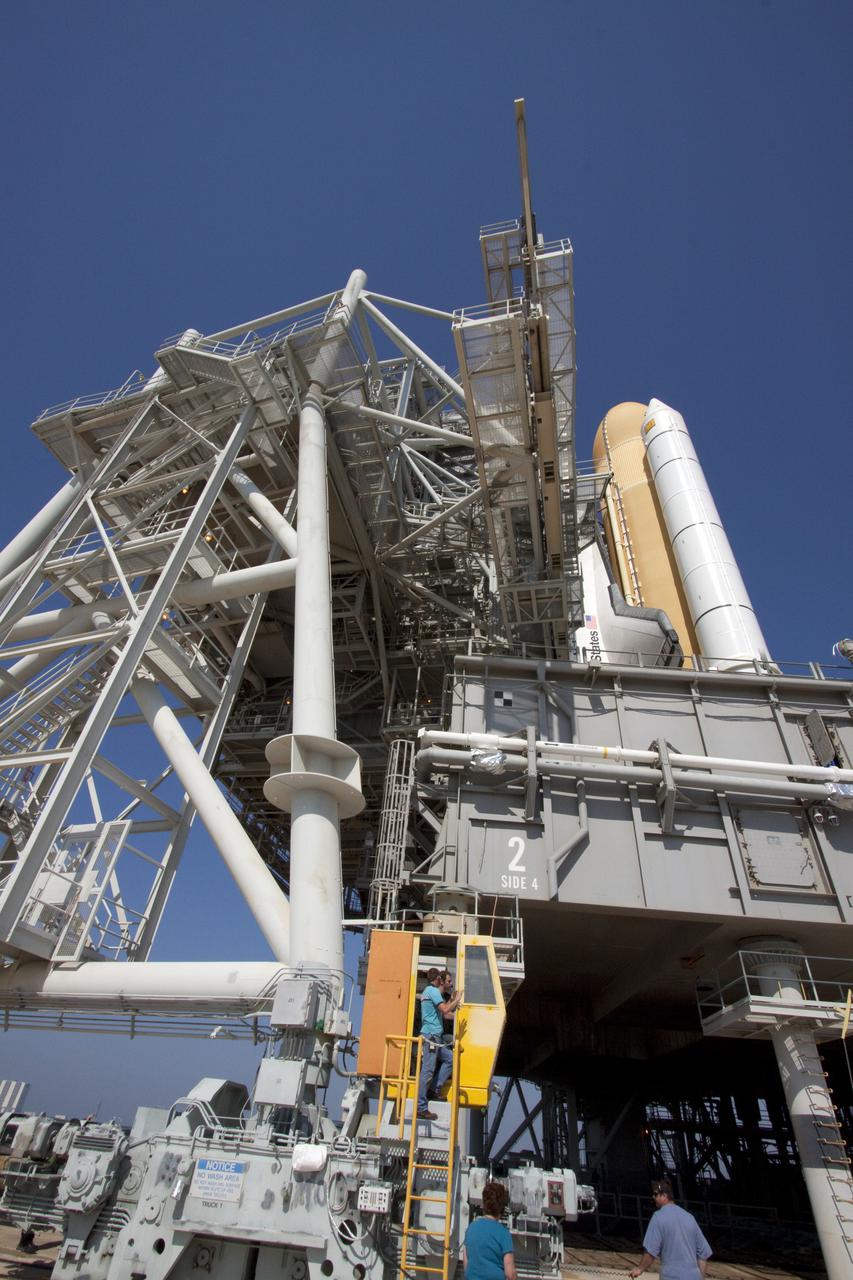 CAPE CANAVERAL, Fla. – On Launch Pad 39A at NASA's Kennedy Space Center in Florida, space shuttle Atlantis is nearly hidden from sight by the rotating service structure closing around it.  This mobile structure provides protected access to the shuttle for installation and servicing of payloads at the pad, as well as servicing access to certain systems on the shuttle.  Atlantis' first motion on its 3.4-mile trip from the Vehicle Assembly Building was at 11:31 p.m. EDT April 21.  The shuttle was secured, or 'hard down,' on the pad at 6:03 a.m. April 22.  Rollout is a significant milestone in launch processing activities.  On the STS-132 mission, the six-member crew will deliver an Integrated Cargo Carrier, or ICC, and the Russian-built Mini-Research Module-1, or MRM-1, to the International Space Station.  The ICC is an unpressurized flat bed pallet and keel yoke assembly used to support the transfer of exterior cargo from the shuttle to the space station.  The MRM-1, known as Rassvet, is the second in a series of new pressurized components for Russia and will be permanently attached to the Earth-facing port of the Zarya control module. Rassvet, which translates to 'dawn,' will be used for cargo storage and will provide an additional docking port to the station.  STS-132 is the 34th mission to the station and the 132nd shuttle mission overall.   Atlantis is targeted to launch on May 14 at 2:19 p.m.  For information on the STS-132 mission, visit http:__www.nasa.gov_mission_pages_shuttle_shuttlemissions_sts132_index.html. Photo credit: NASA_Jack Pfaller