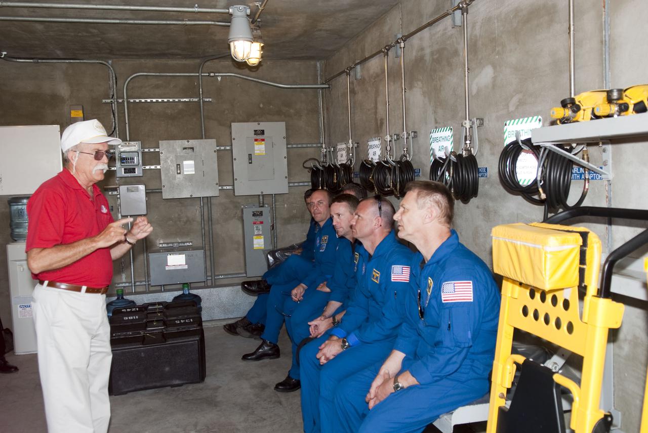 CAPE CANAVERAL, Fla. - At Launch Pad 39A at NASA's Kennedy Space Center, the members of space shuttle Atlantis' STS-132 crew receive instruction on the use of an M-113 armored personnel carrier during emergency exit training.  The M-113 is stationed at the base of the pad.  In the blue flight suits, seated from left, are Mission Specialist Garrett Reisman, Commander Ken Ham, Pilot Tony Antonelli and Mission Specialist Piers Sellers.  The crew is participating in training in preparation for their Terminal Countdown Demonstration Test, or TCDT, a dress rehearsal for launch.  TCDT provides each shuttle crew and launch team the opportunity to participate in various simulated countdown activities, including equipment familiarization and emergency procedures.  On the STS-132 mission, the six-member crew will deliver an Integrated Cargo Carrier, or ICC, and the Russian-built Mini-Research Module-1, or MRM-1, to the International Space Station aboard space shuttle Atlantis.  The ICC is an unpressurized flat bed pallet and keel yoke assembly used to support the transfer of exterior cargo from the shuttle to the space station.  The MRM-1, known as Rassvet, is the second in a series of new pressurized components for Russia and will be permanently attached to the Earth-facing port of the Zarya control module. Rassvet, which translates to 'dawn,' will be used for cargo storage and will provide an additional docking port to the station.  STS-132 is the 34th mission to the station and the 132nd shuttle mission overall.   Atlantis is targeted to launch on May 14 at 2:19 p.m.  For information on the STS-132 mission, visit http:__www.nasa.gov_mission_pages_shuttle_shuttlemissions_sts132_index.html. Photo credit: NASA_Jim Grossmann