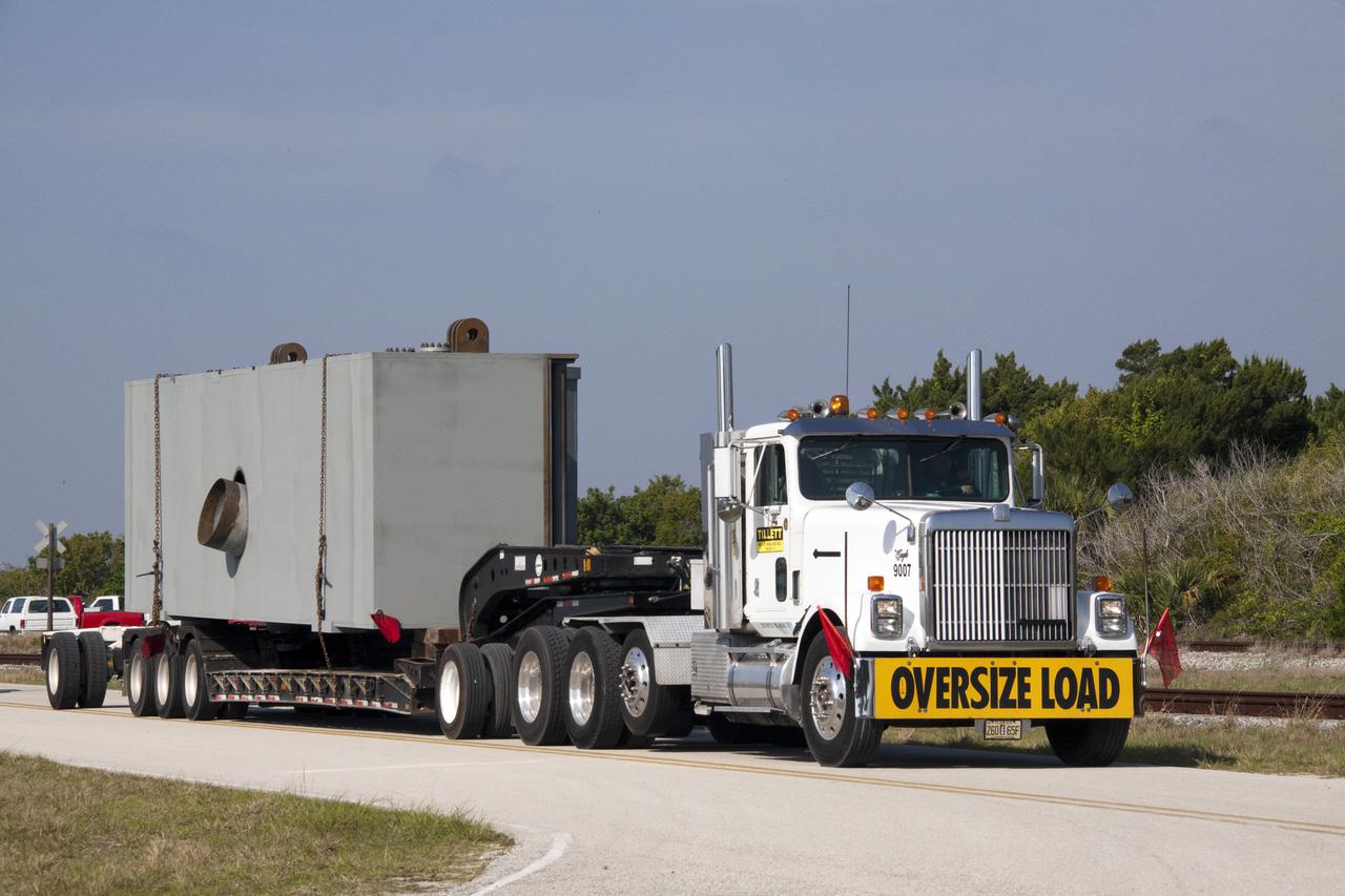 CAPE CANAVERAL, Fla. – At NASA's Kennedy Space Center in Florida, a tractor-trailer delivers the third segment of the launch mount for a new mobile launcher, or ML, being constructed to support NASA's future human spaceflight program.  The construction is taking place in the mobile launcher park site north of Kennedy's Vehicle Assembly Building.  The new launcher is 355 feet tall and has multiple platforms for personnel access. The base of the launcher is lighter than space shuttle mobile launcher platforms so the crawler-transporter can pick up the heavier load of the tower and a taller rocket. For information on NASA's future plans, visit http:__www.nasa.gov. Photo credit: NASA_Jack Pfaller