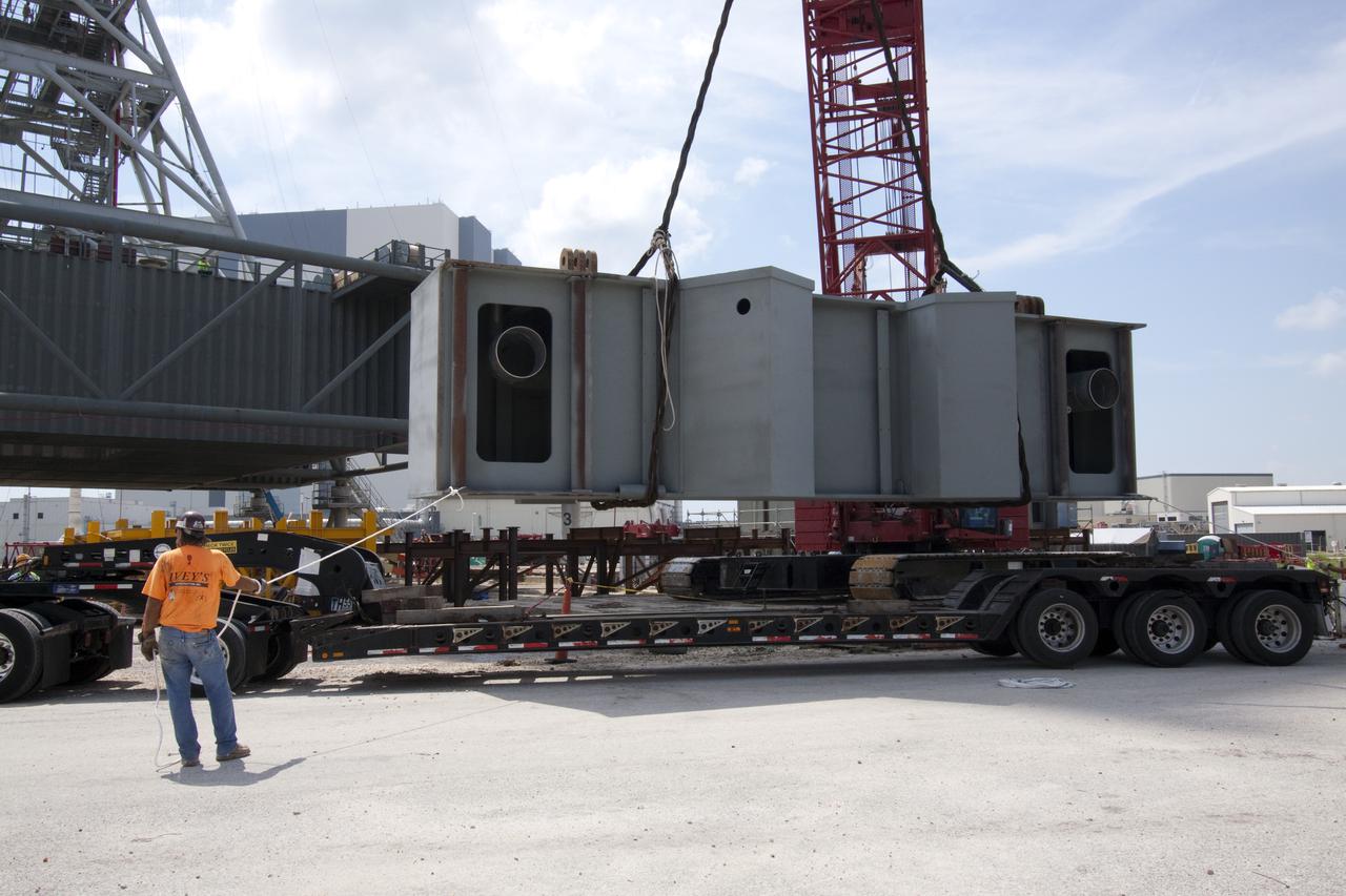 CAPE CANAVERAL, Fla. – At NASA's Kennedy Space Center in Florida, the third segment of the launch mount for a new mobile launcher, or ML, being constructed to support NASA's future human spaceflight program is lifted from the tractor-trailer on which it was delivered.  The construction is taking place in the mobile launcher park site north of Kennedy's Vehicle Assembly Building.  The new launcher is 355 feet tall and has multiple platforms for personnel access. The base of the launcher is lighter than space shuttle mobile launcher platforms so the crawler-transporter can pick up the heavier load of the tower and a taller rocket. For information on NASA's future plans, visit http:__www.nasa.gov. Photo credit: NASA_Jack Pfaller