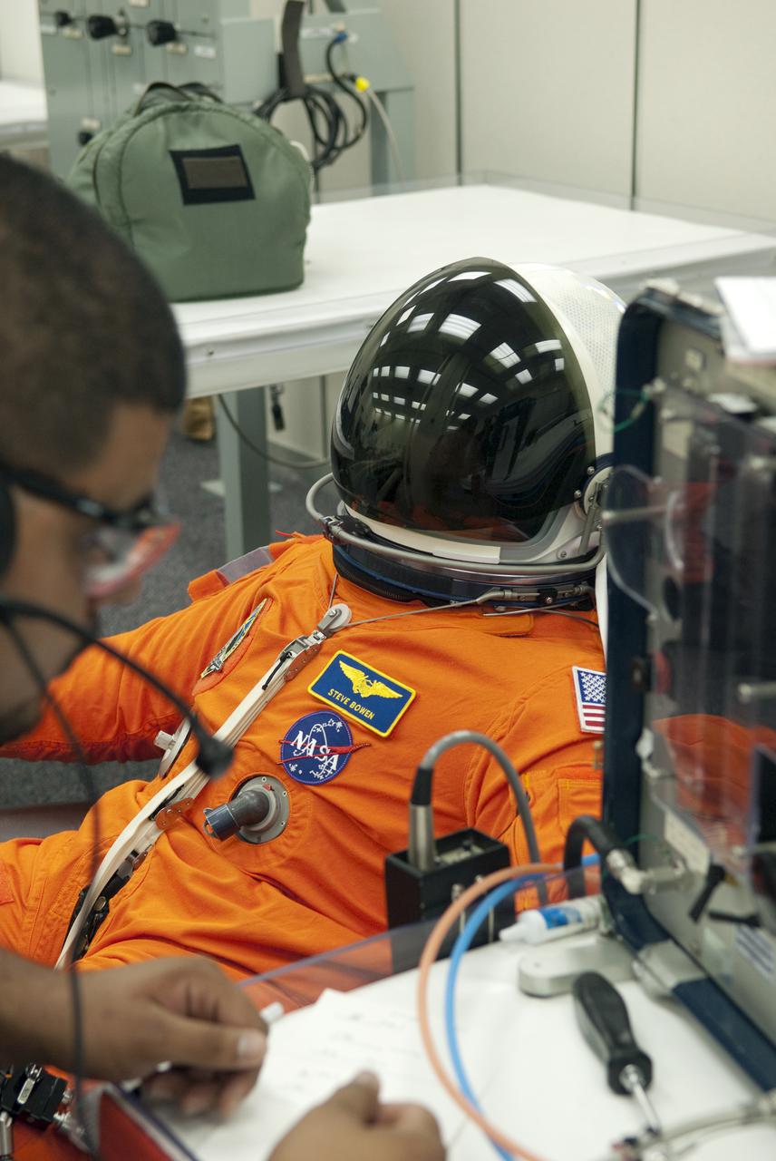CAPE CANAVERAL, Fla. - In the Operations and Checkout Building at NASA's Kennedy Space Center in Florida, STS-132 Mission Specialist Steve Bowen verifies that his space suit's helmet is functioning properly. STS-132 is Bowen's second spaceflight. The six-member STS-132 crew is at Kennedy for their Terminal Countdown Demonstration Test, or TCDT, a dress rehearsal for launch. Following this practice 'suit-up,' the astronauts will ride in the Astrovan to Launch Pad 39A where they will participate in a simulated launch countdown from their seats inside space shuttle Atlantis. Launch is targeted for 2:19 p.m. EDT on May 14. On the STS-132 mission, the crew will deliver an Integrated Cargo Carrier, or ICC, and the Russian-built Mini-Research Module-1, or MRM-1, to the International Space Station. The ICC is an unpressurized flat bed pallet and keel yoke assembly used to support the transfer of exterior cargo from the shuttle to the space station. The MRM-1, known as Rassvet, is the second in a series of new pressurized components for Russia and will be permanently attached to the Earth-facing port of the Zarya control module. Rassvet, which translates to 'dawn,' will be used for cargo storage and provide an additional docking port to the station. STS-132 is the 34th mission to the station and the 132nd shuttle mission overall. For information on the STS-132 mission, visit http:__www.nasa.gov_mission_pages_shuttle_shuttlemissions_sts132_index.html. Photo credit: NASA_Cory Huston