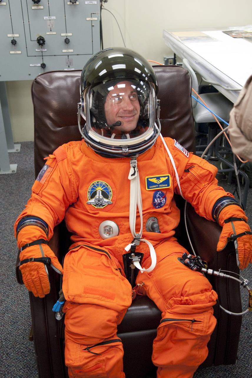 CAPE CANAVERAL, Fla. - In the Operations and Checkout Building at NASA's Kennedy Space Center in Florida, STS-132 Mission Specialist Garrett Reisman tests the performance of his space suit's helmet. Reisman was a flight engineer on the International Space Station's Expedition 16 and 17. The six-member STS-132 crew is at Kennedy for their Terminal Countdown Demonstration Test, or TCDT, a dress rehearsal for launch. Following this practice 'suit-up,' the astronauts will ride in the Astrovan to Launch Pad 39A where they will participate in a simulated launch countdown from their seats inside space shuttle Atlantis. Launch is targeted for 2:19 p.m. EDT on May 14. On the STS-132 mission, the crew will deliver an Integrated Cargo Carrier, or ICC, and the Russian-built Mini-Research Module-1, or MRM-1, to the International Space Station. The ICC is an unpressurized flat bed pallet and keel yoke assembly used to support the transfer of exterior cargo from the shuttle to the space station. The MRM-1, known as Rassvet, is the second in a series of new pressurized components for Russia and will be permanently attached to the Earth-facing port of the Zarya control module. Rassvet, which translates to 'dawn,' will be used for cargo storage and provide an additional docking port to the station. STS-132 is the 34th mission to the station and the 132nd shuttle mission overall. For information on the STS-132 mission, visit http:__www.nasa.gov_mission_pages_shuttle_shuttlemissions_sts132_index.html. Photo credit: NASA_Cory Huston