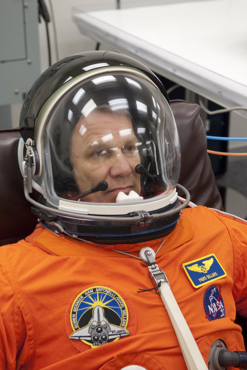 CAPE CANAVERAL, Fla. - In the Operations and Checkout Building at NASA's Kennedy Space Center in Florida, STS-132 Mission Specialist Piers Sellers verifies that his space suit's helmet is functioning properly. STS-132 is Sellers third spaceflight. The six-member STS-132 crew is at Kennedy for their Terminal Countdown Demonstration Test, or TCDT, a dress rehearsal for launch. Following this practice 'suit-up,' the astronauts will ride in the Astrovan to Launch Pad 39A where they will participate in a simulated launch countdown from their seats inside space shuttle Atlantis. Launch is targeted for 2:19 p.m. EDT on May 14. On the STS-132 mission, the crew will deliver an Integrated Cargo Carrier, or ICC, and the Russian-built Mini-Research Module-1, or MRM-1, to the International Space Station. The ICC is an unpressurized flat bed pallet and keel yoke assembly used to support the transfer of exterior cargo from the shuttle to the space station. The MRM-1, known as Rassvet, is the second in a series of new pressurized components for Russia and will be permanently attached to the Earth-facing port of the Zarya control module. Rassvet, which translates to 'dawn,' will be used for cargo storage and provide an additional docking port to the station. STS-132 is the 34th mission to the station and the 132nd shuttle mission overall. For information on the STS-132 mission, visit http:__www.nasa.gov_mission_pages_shuttle_shuttlemissions_sts132_index.html. Photo credit: NASA_Cory Huston