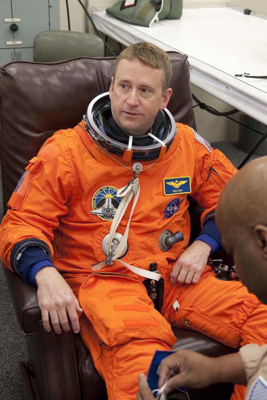 CAPE CANAVERAL, Fla. - In the Operations and Checkout Building at NASA's Kennedy Space Center in Florida, STS-132 Commander Ken Ham puts on his space suit for his second practice countdown. The six-member STS-132 crew is at Kennedy for their Terminal Countdown Demonstration Test, or TCDT, a dress rehearsal for launch. Following this practice 'suit-up,' the astronauts will ride in the Astrovan to Launch Pad 39A where they will participate in a simulated launch countdown from their seats inside space shuttle Atlantis. Launch is targeted for 2:19 p.m. EDT on May 14. On the STS-132 mission, the crew will deliver an Integrated Cargo Carrier, or ICC, and the Russian-built Mini-Research Module-1, or MRM-1, to the International Space Station. The ICC is an unpressurized flat bed pallet and keel yoke assembly used to support the transfer of exterior cargo from the shuttle to the space station. The MRM-1, known as Rassvet, is the second in a series of new pressurized components for Russia and will be permanently attached to the Earth-facing port of the Zarya control module. Rassvet, which translates to 'dawn,' will be used for cargo storage and provide an additional docking port to the station. STS-132 is the 34th mission to the station and the 132nd shuttle mission overall. For information on the STS-132 mission, visit http:__www.nasa.gov_mission_pages_shuttle_shuttlemissions_sts132_index.html. Photo credit: NASA_Cory Huston