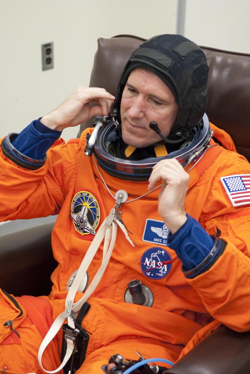 CAPE CANAVERAL, Fla. - In the Operations and Checkout Building at NASA's Kennedy Space Center in Florida, STS-132 Mission Specialist Michael Good prepares to put on his space suit's helmet. STS-132 is Good's second spaceflight. The six-member STS-132 crew is at Kennedy for their Terminal Countdown Demonstration Test, or TCDT, a dress rehearsal for launch. Following this practice 'suit-up,' the astronauts will ride in the Astrovan to Launch Pad 39A where they will participate in a simulated launch countdown from their seats inside space shuttle Atlantis. Launch is targeted for 2:19 p.m. EDT on May 14. On the STS-132 mission, the crew will deliver an Integrated Cargo Carrier, or ICC, and the Russian-built Mini-Research Module-1, or MRM-1, to the International Space Station. The ICC is an unpressurized flat bed pallet and keel yoke assembly used to support the transfer of exterior cargo from the shuttle to the space station. The MRM-1, known as Rassvet, is the second in a series of new pressurized components for Russia and will be permanently attached to the Earth-facing port of the Zarya control module. Rassvet, which translates to 'dawn,' will be used for cargo storage and provide an additional docking port to the station. STS-132 is the 34th mission to the station and the 132nd shuttle mission overall. For information on the STS-132 mission, visit http:__www.nasa.gov_mission_pages_shuttle_shuttlemissions_sts132_index.html. Photo credit: NASA_Cory Huston