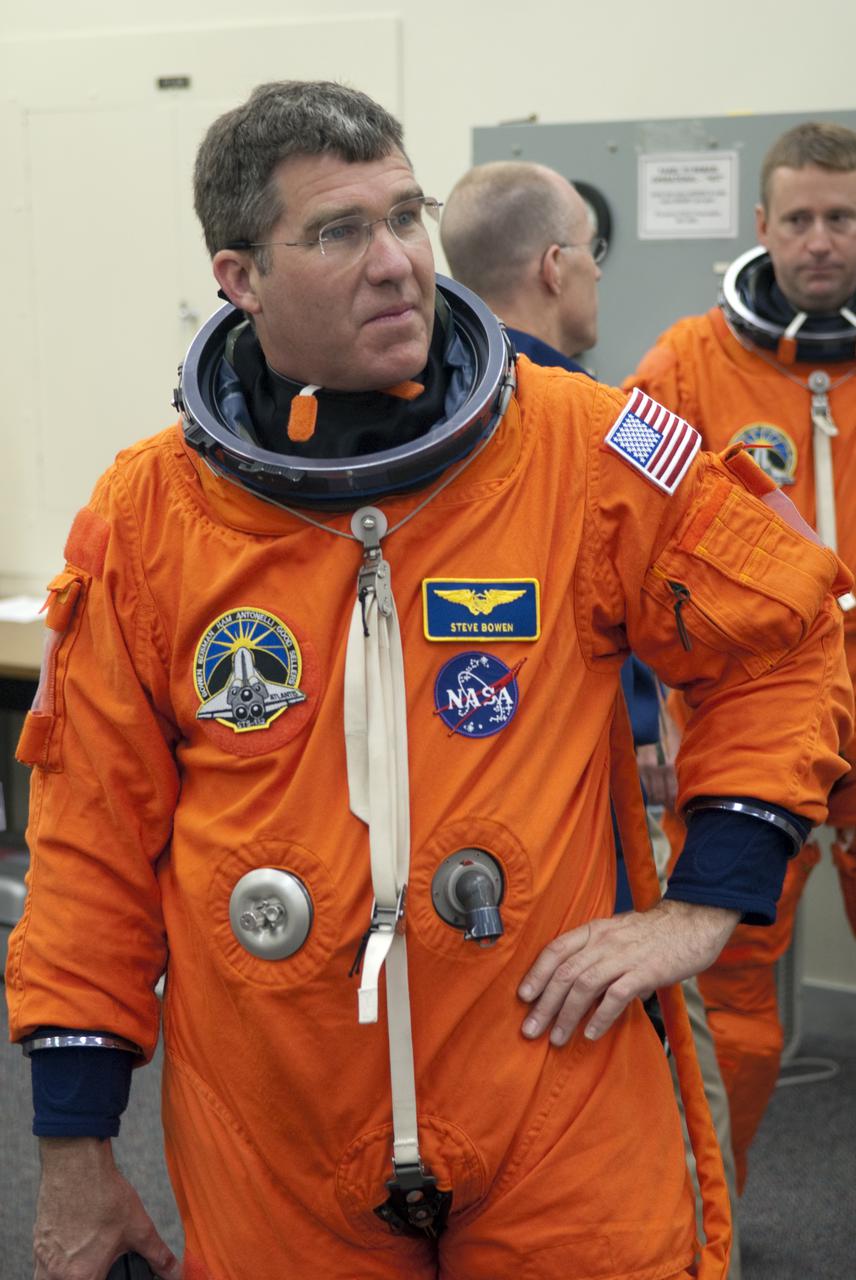 CAPE CANAVERAL, Fla. - In the Operations and Checkout Building at NASA's Kennedy Space Center in Florida, STS-132 Mission Specialist Steve Bowen suits up for his second practice countdown. The six-member STS-132 crew is at Kennedy for their Terminal Countdown Demonstration Test, or TCDT, a dress rehearsal for launch. Following this practice 'suit-up,' the astronauts will ride in the Astrovan to Launch Pad 39A where they will participate in a simulated launch countdown from their seats inside space shuttle Atlantis. Launch is targeted for 2:19 p.m. EDT on May 14. On the STS-132 mission, the crew will deliver an Integrated Cargo Carrier, or ICC, and the Russian-built Mini-Research Module-1, or MRM-1, to the International Space Station. The ICC is an unpressurized flat bed pallet and keel yoke assembly used to support the transfer of exterior cargo from the shuttle to the space station. The MRM-1, known as Rassvet, is the second in a series of new pressurized components for Russia and will be permanently attached to the Earth-facing port of the Zarya control module. Rassvet, which translates to 'dawn,' will be used for cargo storage and provide an additional docking port to the station. STS-132 is the 34th mission to the station and the 132nd shuttle mission overall. For information on the STS-132 mission, visit http:__www.nasa.gov_mission_pages_shuttle_shuttlemissions_sts132_index.html. Photo credit: NASA_Cory Huston