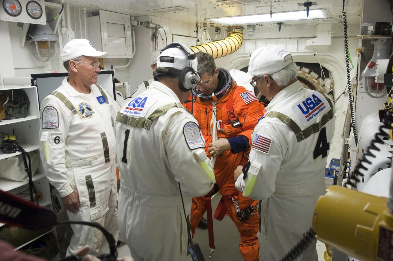 CAPE CANAVERAL, Fla. - At Launch Pad 39A at NASA's Kennedy Space Center in Florida, STS-132 Mission Specialist Steve Bowen prepares to enter space shuttle Atlantis from the pad's White Room.  STS-132 is Bowen's second spaceflight.  The six-member STS-132 crew is participating in a dress rehearsal for launch, known as the Terminal Countdown Demonstration Test, from their seats in the crew compartment of Atlantis.  Launch is targeted for 2:19 p.m. EDT on May 14.  On the STS-132 mission, the crew will deliver an Integrated Cargo Carrier, or ICC, and the Russian-built Mini-Research Module-1, or MRM-1, to the International Space Station.  The ICC is an unpressurized flat bed pallet and keel yoke assembly used to support the transfer of exterior cargo from the shuttle to the space station.  The MRM-1, known as Rassvet, is the second in a series of new pressurized components for Russia and will be permanently attached to the Earth-facing port of the Zarya control module. Rassvet, which translates to 'dawn,' will be used for cargo storage and provide an additional docking port to the station.  STS-132 is the 34th mission to the station and the 132nd shuttle mission overall.  For information on the STS-132 mission, visit http:__www.nasa.gov_mission_pages_shuttle_shuttlemissions_sts132_index.html. Photo credit: NASA_Sandra Joseph and Kevin O'Connell