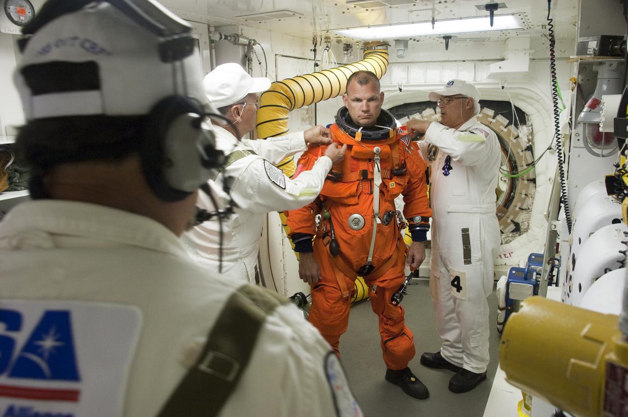 CAPE CANAVERAL, Fla. - At Launch Pad 39A at NASA's Kennedy Space Center in Florida, STS-132 Pilot Tony Antonelli prepares to enter space shuttle Atlantis from the pad's White Room.  STS-132 is Antonelli's second spaceflight.  The six-member STS-132 crew is participating in a dress rehearsal for launch, known as the Terminal Countdown Demonstration Test, from their seats in the crew compartment of Atlantis.  Launch is targeted for 2:19 p.m. EDT on May 14.  On the STS-132 mission, the crew will deliver an Integrated Cargo Carrier, or ICC, and the Russian-built Mini-Research Module-1, or MRM-1, to the International Space Station.  The ICC is an unpressurized flat bed pallet and keel yoke assembly used to support the transfer of exterior cargo from the shuttle to the space station.  The MRM-1, known as Rassvet, is the second in a series of new pressurized components for Russia and will be permanently attached to the Earth-facing port of the Zarya control module. Rassvet, which translates to 'dawn,' will be used for cargo storage and provide an additional docking port to the station.  STS-132 is the 34th mission to the station and the 132nd shuttle mission overall.  For information on the STS-132 mission, visit http:__www.nasa.gov_mission_pages_shuttle_shuttlemissions_sts132_index.html. Photo credit: NASA_Sandra Joseph and Kevin O'Connell