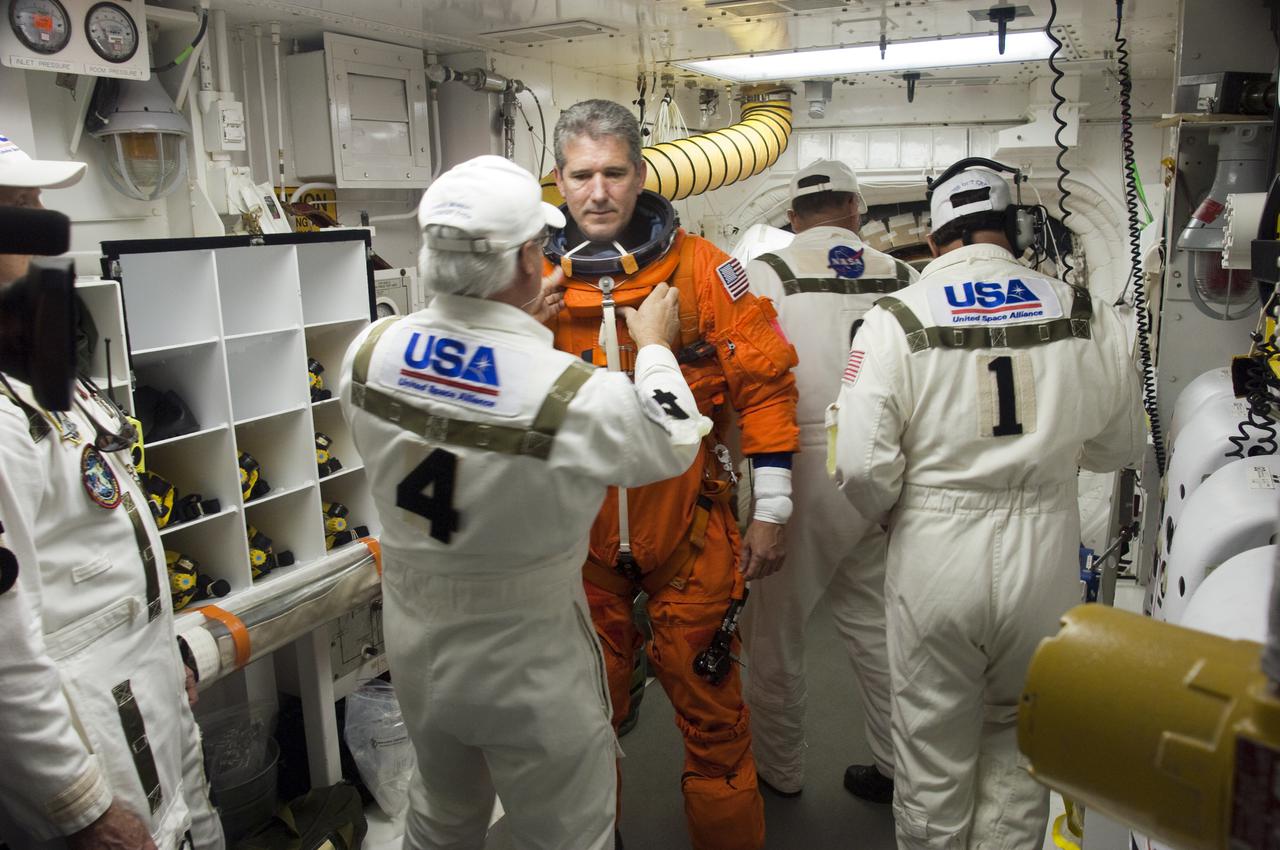 CAPE CANAVERAL, Fla. - At Launch Pad 39A at NASA's Kennedy Space Center in Florida, STS-132 Mission Specialist Michael Good prepares to enter space shuttle Atlantis from the pad's White Room.  STS-132 is Good's second spaceflight.  The six-member STS-132 crew is participating in a dress rehearsal for launch, known as the Terminal Countdown Demonstration Test, from their seats in the crew compartment of Atlantis.  Launch is targeted for 2:19 p.m. EDT on May 14.  On the STS-132 mission, the crew will deliver an Integrated Cargo Carrier, or ICC, and the Russian-built Mini-Research Module-1, or MRM-1, to the International Space Station.  The ICC is an unpressurized flat bed pallet and keel yoke assembly used to support the transfer of exterior cargo from the shuttle to the space station.  The MRM-1, known as Rassvet, is the second in a series of new pressurized components for Russia and will be permanently attached to the Earth-facing port of the Zarya control module. Rassvet, which translates to 'dawn,' will be used for cargo storage and provide an additional docking port to the station.  STS-132 is the 34th mission to the station and the 132nd shuttle mission overall.  For information on the STS-132 mission, visit http:__www.nasa.gov_mission_pages_shuttle_shuttlemissions_sts132_index.html. Photo credit: NASA_Sandra Joseph and Kevin O'Connell