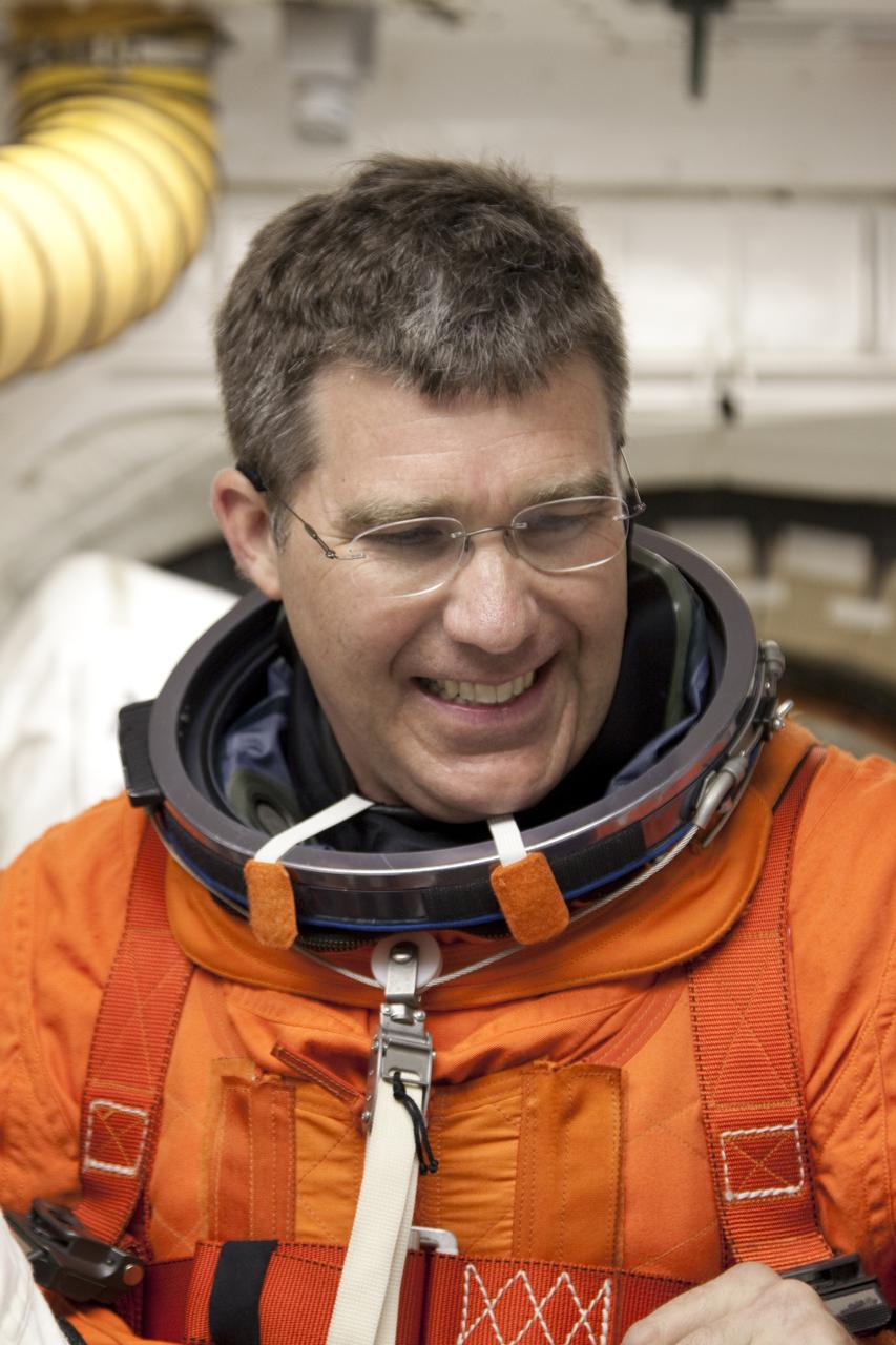 CAPE CANAVERAL, Fla. - At Launch Pad 39A at NASA's Kennedy Space Center in Florida, STS-132 Mission Specialist Steve Bowen prepares to enter space shuttle Atlantis from the pad's White Room.  STS-132 is Bowen's second spaceflight.  The six-member STS-132 crew is participating in a dress rehearsal for launch, known as the Terminal Countdown Demonstration Test, from their seats in the crew compartment of space shuttle Atlantis.  Launch is targeted for 2:19 p.m. EDT on May 14.  On the STS-132 mission, the crew will deliver an Integrated Cargo Carrier, or ICC, and the Russian-built Mini-Research Module-1, or MRM-1, to the International Space Station.  The ICC is an unpressurized flat bed pallet and keel yoke assembly used to support the transfer of exterior cargo from the shuttle to the space station.  The MRM-1, known as Rassvet, is the second in a series of new pressurized components for Russia and will be permanently attached to the Earth-facing port of the Zarya control module. Rassvet, which translates to 'dawn,' will be used for cargo storage and provide an additional docking port to the station.  STS-132 is the 34th mission to the station and the 132nd shuttle mission overall.  For information on the STS-132 mission, visit http:__www.nasa.gov_mission_pages_shuttle_shuttlemissions_sts132_index.html. Photo credit: NASA_Jack Pfaller