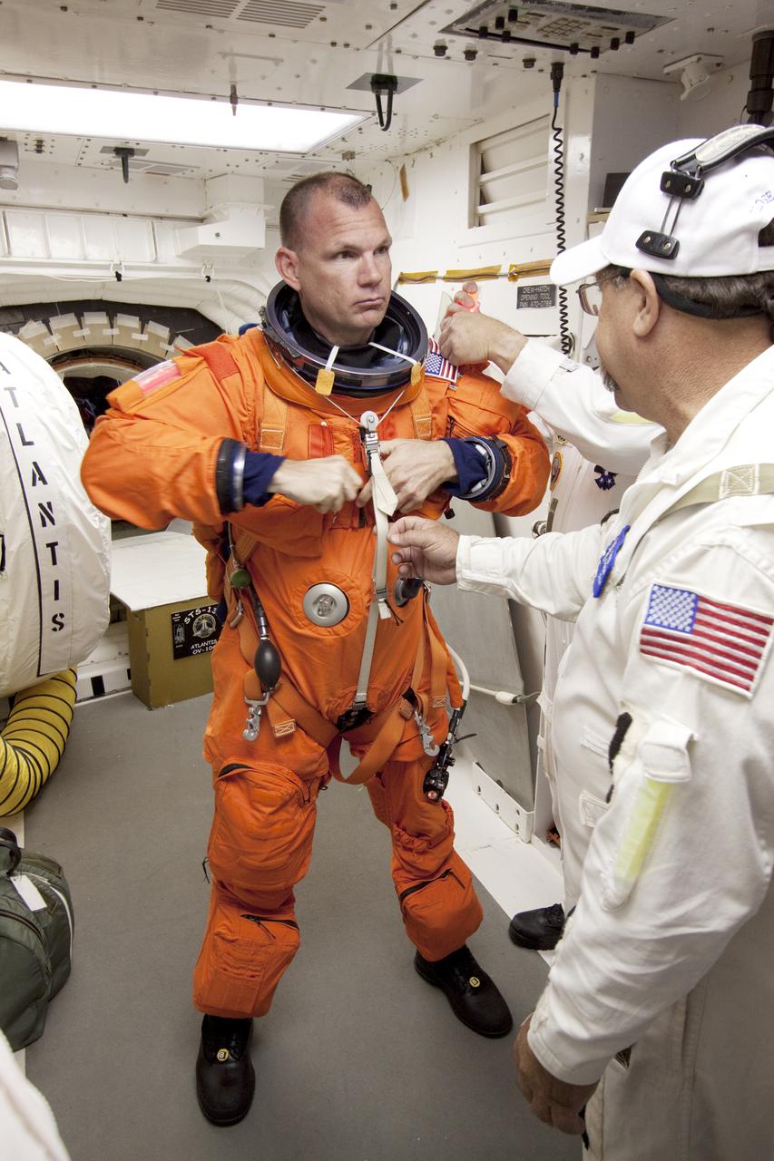 CAPE CANAVERAL, Fla. - At Launch Pad 39A at NASA's Kennedy Space Center in Florida, STS-132 Pilot Tony Antonelli prepares to enter space shuttle Atlantis from the pad's White Room.  STS-132 is Antonelli's second spaceflight.  The six-member STS-132 crew is participating in a dress rehearsal for launch, known as the Terminal Countdown Demonstration Test, from their seats in the crew compartment of space shuttle Atlantis.  Launch is targeted for 2:19 p.m. EDT on May 14.  On the STS-132 mission, the crew will deliver an Integrated Cargo Carrier, or ICC, and the Russian-built Mini-Research Module-1, or MRM-1, to the International Space Station.  The ICC is an unpressurized flat bed pallet and keel yoke assembly used to support the transfer of exterior cargo from the shuttle to the space station.  The MRM-1, known as Rassvet, is the second in a series of new pressurized components for Russia and will be permanently attached to the Earth-facing port of the Zarya control module. Rassvet, which translates to 'dawn,' will be used for cargo storage and provide an additional docking port to the station.  STS-132 is the 34th mission to the station and the 132nd shuttle mission overall.  For information on the STS-132 mission, visit http:__www.nasa.gov_mission_pages_shuttle_shuttlemissions_sts132_index.html. Photo credit: NASA_Jack Pfaller