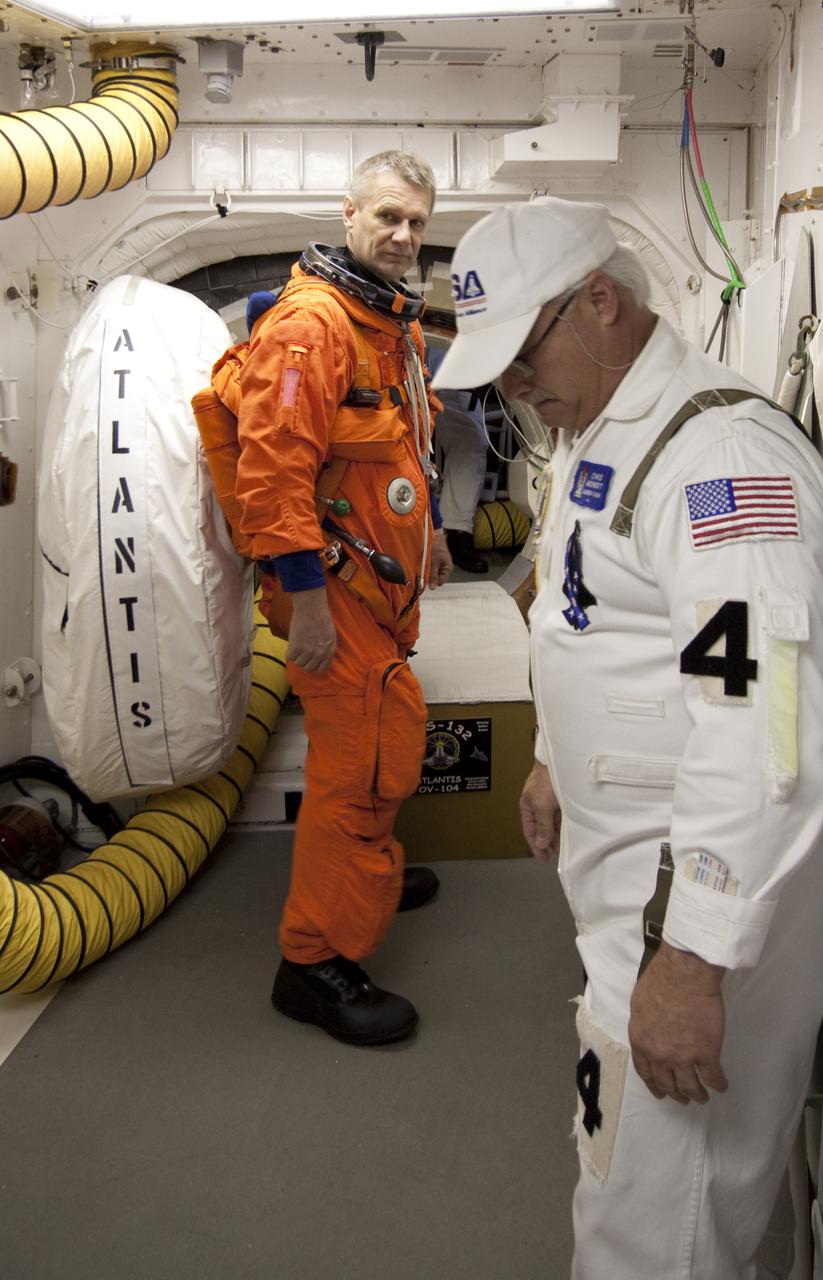 CAPE CANAVERAL, Fla. - At Launch Pad 39A at NASA's Kennedy Space Center in Florida, STS-132 Mission Specialist Piers Sellers prepares to enter space shuttle Atlantis from the pad's White Room.  STS-132 is Seller's third spaceflight.  The six-member STS-132 crew is participating in a dress rehearsal for launch, known as the Terminal Countdown Demonstration Test, from their seats in the crew compartment of space shuttle Atlantis.  Launch is targeted for 2:19 p.m. EDT on May 14.  On the STS-132 mission, the crew will deliver an Integrated Cargo Carrier, or ICC, and the Russian-built Mini-Research Module-1, or MRM-1, to the International Space Station.  The ICC is an unpressurized flat bed pallet and keel yoke assembly used to support the transfer of exterior cargo from the shuttle to the space station.  The MRM-1, known as Rassvet, is the second in a series of new pressurized components for Russia and will be permanently attached to the Earth-facing port of the Zarya control module. Rassvet, which translates to 'dawn,' will be used for cargo storage and provide an additional docking port to the station.  STS-132 is the 34th mission to the station and the 132nd shuttle mission overall.  For information on the STS-132 mission, visit http:__www.nasa.gov_mission_pages_shuttle_shuttlemissions_sts132_index.html. Photo credit: NASA_Jack Pfaller