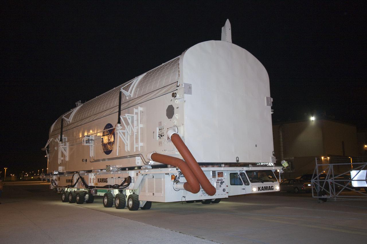 CAPE CANAVERAL, Fla. - At NASA's Kennedy Space Center in Florida, a payload canister arrives at Orbiter Processing Facility-3 in preparation for the removal of the multi-purpose logistics module Leonardo and an ammonia tank assembly from space shuttle Discovery's payload bay.  Discovery landed on Runway 33 at Kennedy's Shuttle Landing Facility at 9:08 a.m. EDT April 20 after 15 days in space, completing the more than 6.2-million-mile STS-131 mission on orbit 238.  The seven-member STS-131 crew carried the multi-purpose logistics module Leonardo, filled with supplies, a new crew sleeping quarters and science racks that were transferred to the International Space Station's laboratories.  Leonardo now will be modified into a permanent multi-purpose module, or PMM, and left aboard the station on space shuttle Discovery's STS-133 mission, targeted for launch Sept. 16.  For information on the STS-131 mission, visit http:__www.nasa.gov_mission_pages_shuttle_shuttlemissions_sts131_index.html.  For information on the STS-133 mission, visit http:__www.nasa.gov_mission_pages_shuttle_shuttlemissions_sts133_index.html.  Photo credit: NASA_Jack Pfaller