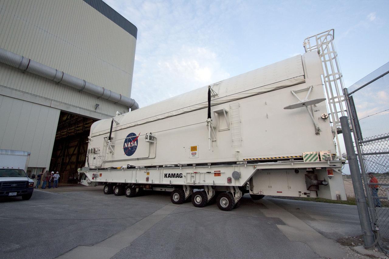 CAPE CANAVERAL, Fla. - At NASA's Kennedy Space Center in Florida, a payload canister rolls through the open bay door of Orbiter Processing Facility-3 into the transfer aisle in preparation for the removal of the multi-purpose logistics module Leonardo and an ammonia tank assembly from space shuttle Discovery's payload bay.  Discovery landed on Runway 33 at Kennedy's Shuttle Landing Facility at 9:08 a.m. EDT April 20 after 15 days in space, completing the more than 6.2-million-mile STS-131 mission on orbit 238.  The seven-member STS-131 crew carried the multi-purpose logistics module Leonardo, filled with supplies, a new crew sleeping quarters and science racks that were transferred to the International Space Station's laboratories.  Leonardo now will be modified into a permanent multi-purpose module, or PMM, and left aboard the station on space shuttle Discovery's STS-133 mission, targeted for launch Sept. 16.  For information on the STS-131 mission, visit http:__www.nasa.gov_mission_pages_shuttle_shuttlemissions_sts131_index.html.  For information on the STS-133 mission, visit http:__www.nasa.gov_mission_pages_shuttle_shuttlemissions_sts133_index.html.  Photo credit: NASA_Jack Pfaller