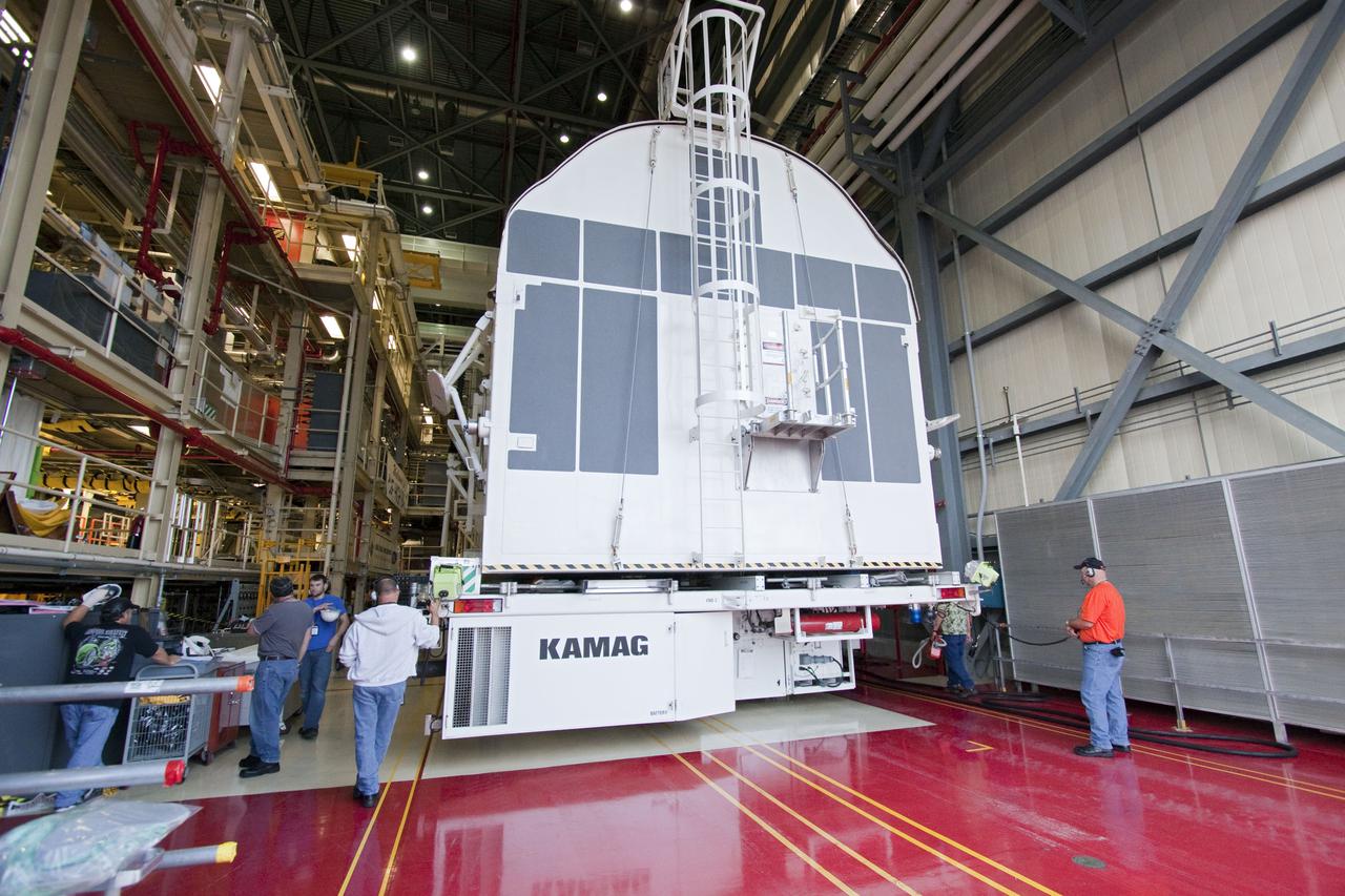 CAPE CANAVERAL, Fla. - At NASA's Kennedy Space Center in Florida, a payload canister arrives in the transfer aisle of Orbiter Processing Facility-3 in preparation for the removal of the multi-purpose logistics module Leonardo and an ammonia tank assembly from space shuttle Discovery's payload bay.  Discovery landed on Runway 33 at Kennedy's Shuttle Landing Facility at 9:08 a.m. EDT April 20 after 15 days in space, completing the more than 6.2-million-mile STS-131 mission on orbit 238.  The seven-member STS-131 crew carried the multi-purpose logistics module Leonardo, filled with supplies, a new crew sleeping quarters and science racks that were transferred to the International Space Station's laboratories.  Leonardo now will be modified into a permanent multi-purpose module, or PMM, and left aboard the station on space shuttle Discovery's STS-133 mission, targeted for launch Sept. 16.  For information on the STS-131 mission, visit http:__www.nasa.gov_mission_pages_shuttle_shuttlemissions_sts131_index.html.  For information on the STS-133 mission, visit http:__www.nasa.gov_mission_pages_shuttle_shuttlemissions_sts133_index.html.  Photo credit: NASA_Jack Pfaller