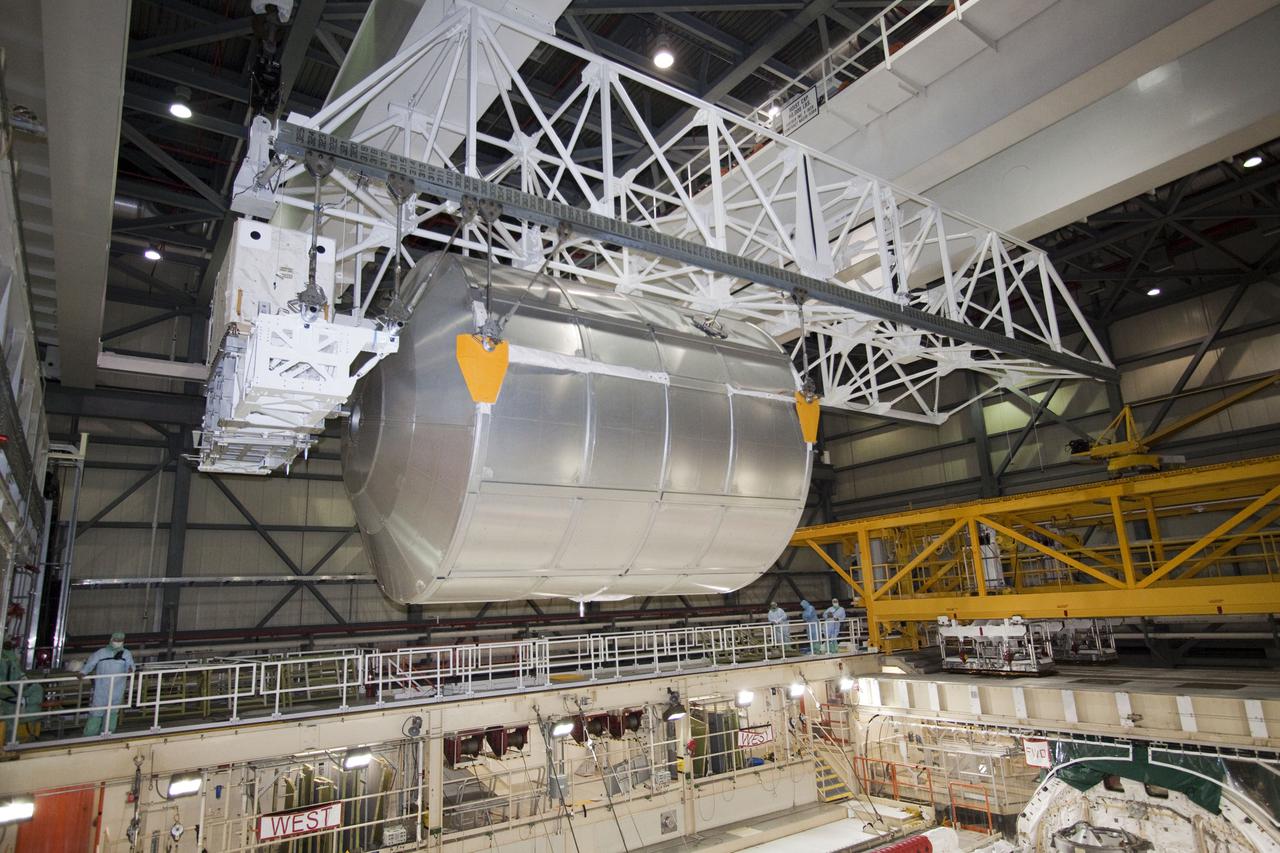 CAPE CANAVERAL, Fla. - In Orbiter Processing Facility-3 at NASA's Kennedy Space Center in Florida, the multi-purpose logistics module Leonardo and an ammonia tank assembly glide across the room from space shuttle Discovery's payload bay toward a payload canister.  Discovery landed on Runway 33 at Kennedy's Shuttle Landing Facility at 9:08 a.m. EDT April 20 after 15 days in space, completing the more than 6.2-million-mile STS-131 mission on orbit 238.  The seven-member STS-131 crew carried the multi-purpose logistics module Leonardo, filled with supplies, a new crew sleeping quarters and science racks that were transferred to the International Space Station's laboratories.  Leonardo now will be modified into a permanent multi-purpose module, or PMM, and left aboard the station on space shuttle Discovery's STS-133 mission, targeted for launch Sept. 16.  For information on the STS-131 mission, visit http:__www.nasa.gov_mission_pages_shuttle_shuttlemissions_sts131_index.html.  For information on the STS-133 mission, visit http:__www.nasa.gov_mission_pages_shuttle_shuttlemissions_sts133_index.html.  Photo credit: NASA_Jack Pfaller
