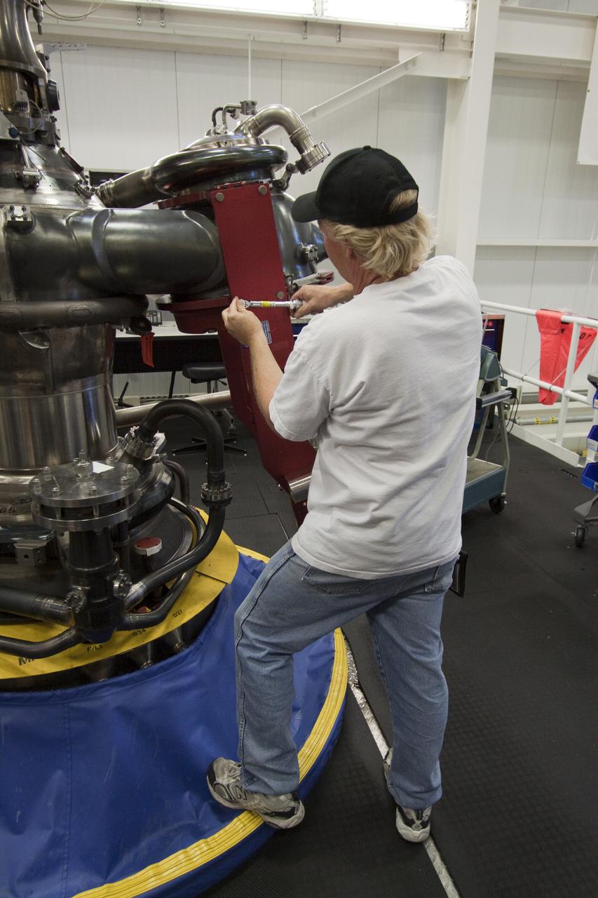 CAPE CANAVERAL, Fla. – At NASA's Kennedy Space Center in Florida, Pratt and Whitney Rocketdyne aerospace technician Ken Burley works on space shuttle main engine, or SSME, #2062 in the Space Shuttle Main Engine Processing Facility. This is the last SSME scheduled to be built at Kennedy before the end of the Space Shuttle Program.  Three main engines are clustered at the aft end of the shuttle and have a combined thrust of more than 1.2 million pounds.  Each engine utilizes liquid hydrogen for fuel and liquid oxygen as oxidizer and operates during the entire eight-and-a-half minute ride to orbit.  Post-flight inspections and maintenance of each engine also are conducted in the SSME Processing Facility between shuttle missions.  Photo credit: NASA_Jack Pfaller