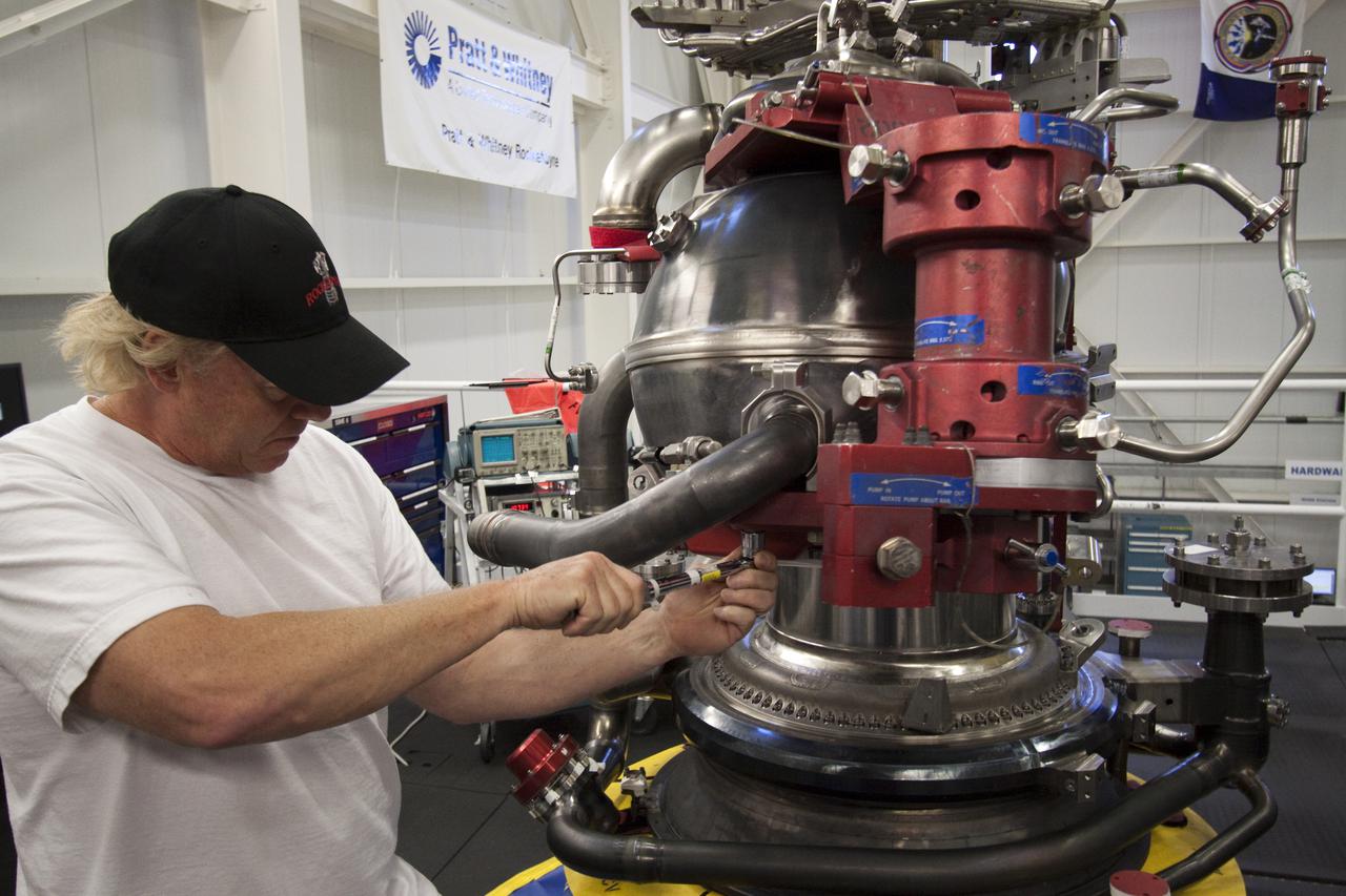 CAPE CANAVERAL, Fla. – At NASA's Kennedy Space Center in Florida, Pratt and Whitney Rocketdyne aerospace technician Ken Burley constructs space shuttle main engine, or SSME, #2062 in the Space Shuttle Main Engine Processing Facility. This is the last SSME scheduled to be built at Kennedy before the end of the Space Shuttle Program.  Three main engines are clustered at the aft end of the shuttle and have a combined thrust of more than 1.2 million pounds.  Each engine utilizes liquid hydrogen for fuel and liquid oxygen as oxidizer and operates during the entire eight-and-a-half minute ride to orbit.  Post-flight inspections and maintenance of each engine also are conducted in the SSME Processing Facility between shuttle missions.  Photo credit: NASA_Jack Pfaller