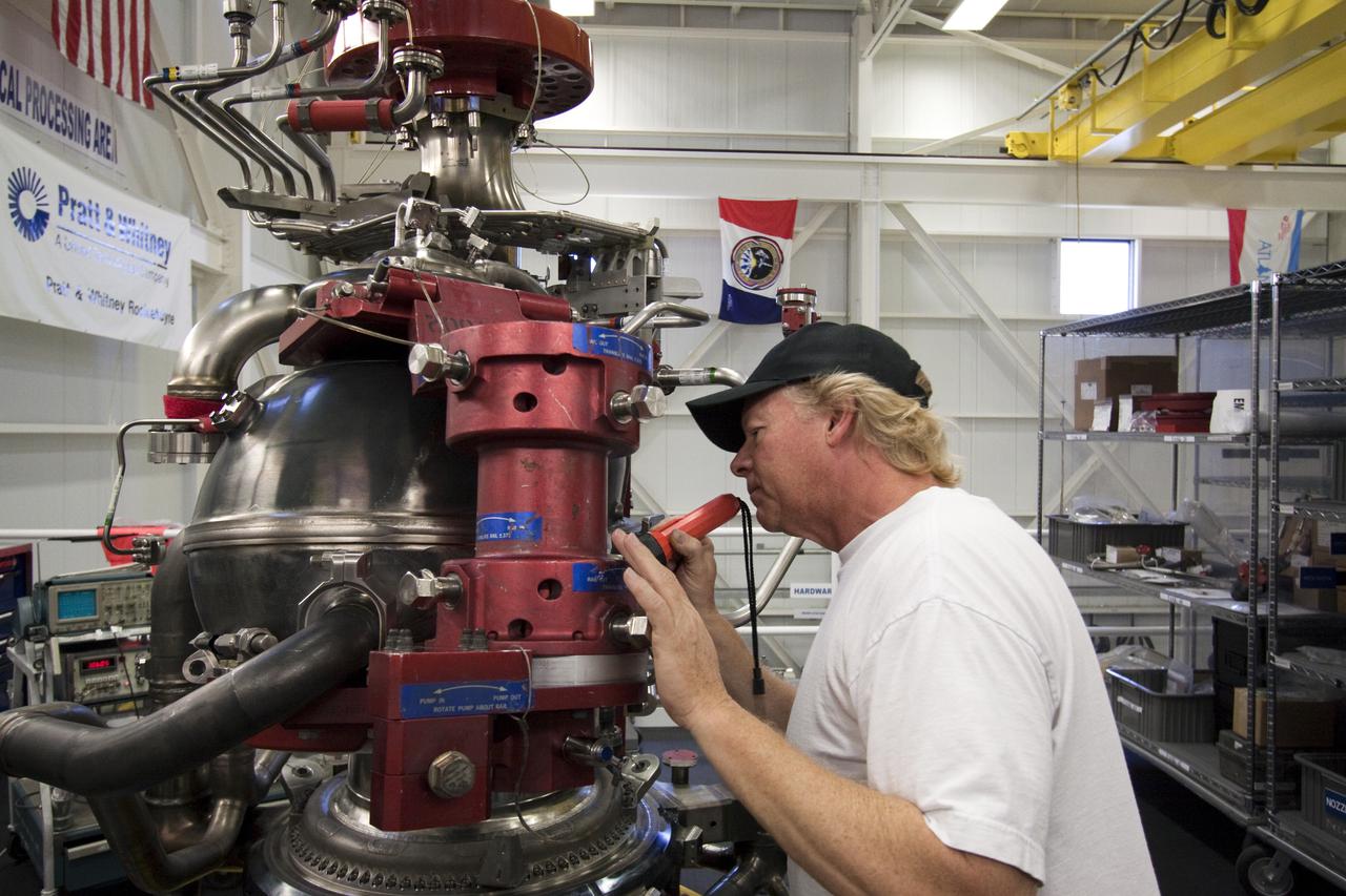 CAPE CANAVERAL, Fla. – At NASA's Kennedy Space Center in Florida, Pratt and Whitney Rocketdyne aerospace technician Ken Burley inspects the inner workings of space shuttle main engine, or SSME, #2062 in the Space Shuttle Main Engine Processing Facility. This is the last SSME scheduled to be built at Kennedy before the end of the Space Shuttle Program.  Three main engines are clustered at the aft end of the shuttle and have a combined thrust of more than 1.2 million pounds.  Each engine utilizes liquid hydrogen for fuel and liquid oxygen as oxidizer and operates during the entire eight-and-a-half minute ride to orbit.  Post-flight inspections and maintenance of each engine also are conducted in the SSME Processing Facility between shuttle missions.  Photo credit: NASA_Jack Pfaller