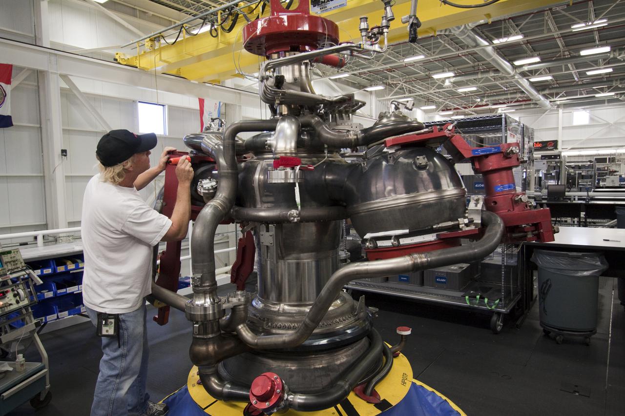CAPE CANAVERAL, Fla. – At NASA's Kennedy Space Center in Florida, Pratt and Whitney Rocketdyne aerospace technician Ken Burley inspects the construction of space shuttle main engine, or SSME, #2062 in the Space Shuttle Main Engine Processing Facility. This is the last SSME scheduled to be built at Kennedy before the end of the Space Shuttle Program.  Three main engines are clustered at the aft end of the shuttle and have a combined thrust of more than 1.2 million pounds.  Each engine utilizes liquid hydrogen for fuel and liquid oxygen as oxidizer and operates during the entire eight-and-a-half minute ride to orbit.  Post-flight inspections and maintenance of each engine also are conducted in the SSME Processing Facility between shuttle missions.  Photo credit: NASA_Jack Pfaller