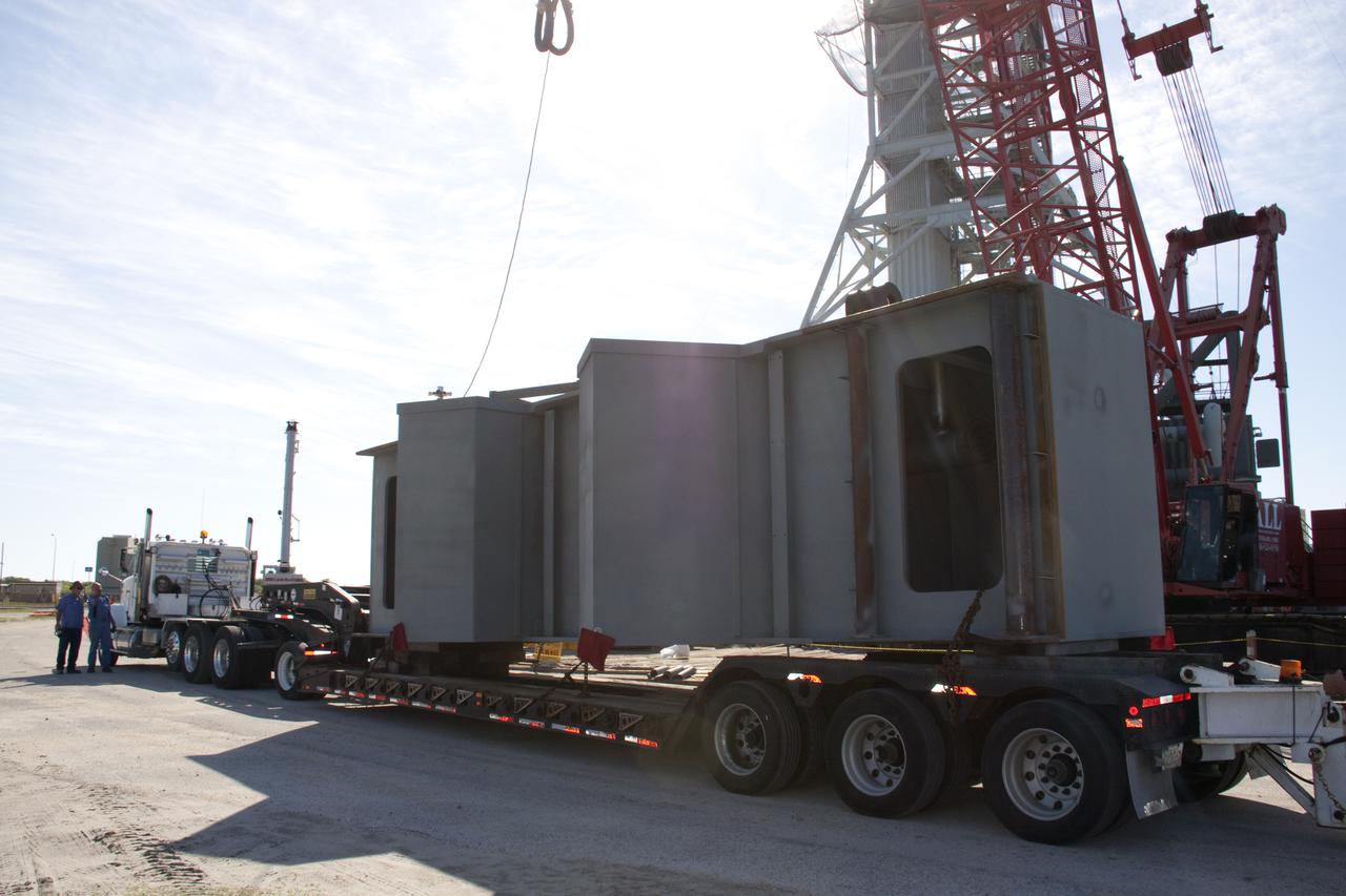 CAPE CANAVERAL, Fla. – At NASA's Kennedy Space Center in Florida, a tractor-trailer delivers the fourth segment of the launch mount for a new mobile launcher, or ML, being constructed to support NASA's future human spaceflight program.  The construction is taking place in the mobile launcher park site north of Kennedy's Vehicle Assembly Building.  The new launcher is 355 feet tall and has multiple platforms for personnel access. The base of the launcher is lighter than space shuttle mobile launcher platforms so the crawler-transporter can pick up the heavier load of the tower and a taller rocket. For information on NASA's future plans, visit http:__www.nasa.gov. Photo credit: NASA_Troy Cryder