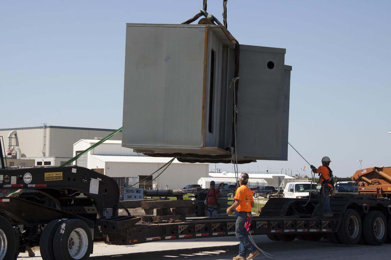 CAPE CANAVERAL, Fla. – At NASA's Kennedy Space Center in Florida, a crane lifts the fourth segment of the launch mount for a new mobile launcher, or ML, being constructed to support NASA's future human spaceflight program, from the tractor-trailer on which it was delivered. The construction is taking place in the mobile launcher park site north of Kennedy's Vehicle Assembly Building. The new launcher is 355 feet tall and has multiple platforms for personnel access. The base of the launcher is lighter than space shuttle mobile launcher platforms so the crawler-transporter can pick up the heavier load of the tower and a taller rocket. For information on NASA's future plans, visit http:__www.nasa.gov. Photo credit: NASA_Troy Cryder