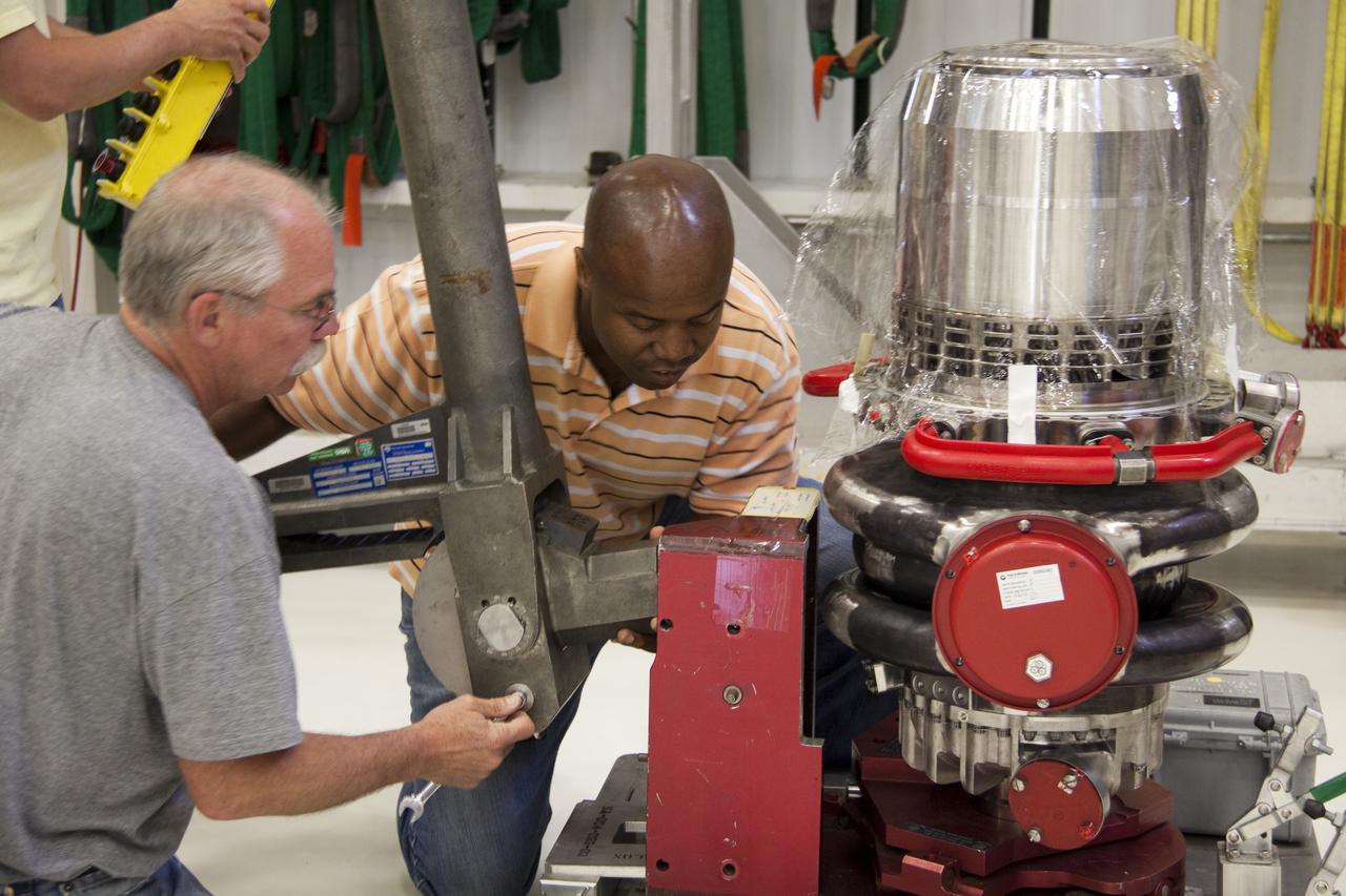 CAPE CANAVERAL, Fla. – In the Space Shuttle Main Engine Processing Facility at NASA's Kennedy Space Center in Florida, Pratt and Whitney Rocketdyne engine technicians prepare a high pressure oxidizer turbo pump for installation on space shuttle main engine no. 2062. The engine, or SSME, is the last one scheduled to be built at Kennedy by Pratt and Whitney Rocketdyne before the end of the Space Shuttle Program. From left are Dan Bode and Teryon Jones. Three main engines are clustered at the aft end of the shuttle and have a combined thrust of more than 1.2 million pounds. Even though an SSME weighs one-seventh as much as a locomotive engine, its high-pressure fuel pump alone delivers as much horsepower as 28 locomotives. Each engine operates during the entire eight-and-a-half minute climb to orbit. Post-flight inspections and maintenance of each engine also are conducted in the SSME Processing Facility between shuttle missions. Photo credit: NASA_Amanda Diller