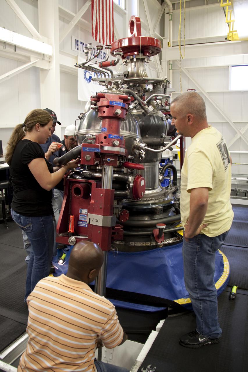 CAPE CANAVERAL, Fla. – In the Space Shuttle Main Engine Processing Facility at NASA's Kennedy Space Center in Florida, a team of Pratt and Whitney Rocketdyne employees installs a high pressure oxidizer turbo pump on space shuttle main engine no. 2062.  The engine, or SSME, is the last one scheduled to be built at Kennedy before the end of the Space Shuttle Program. Around the engine, from right to left, are engine technicians Ryan Mahony and Teryon Jones, engineer Jessica Tandy, engine technician Ken Burley and quality inspector Barry Martin.  Three main engines are clustered at the aft end of the shuttle and have a combined thrust of more than 1.2 million pounds.  Even though an SSME weighs one-seventh as much as a locomotive engine, its high-pressure fuel pump alone delivers as much horsepower as 28 locomotives.  Each engine operates during the entire eight-and-a-half minute climb to orbit.  Post-flight inspections and maintenance of each engine also are conducted in the SSME Processing Facility between shuttle missions.  Photo credit: NASA_Amanda Diller