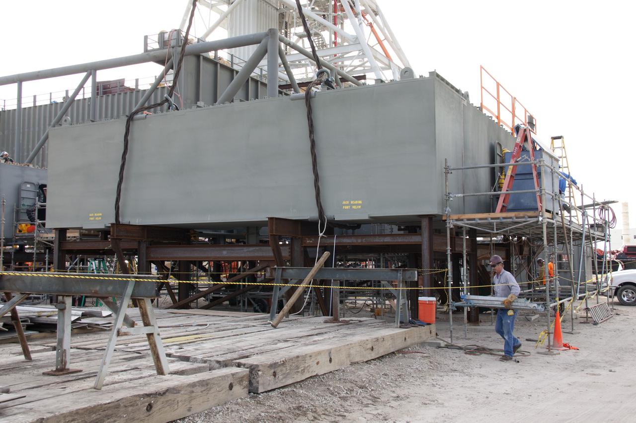 CAPE CANAVERAL, Fla. – At NASA's Kennedy Space Center in Florida, works begins to construct the launch mount for a new mobile launcher, or ML, which will support NASA's future human spaceflight program, following the arrival of all eight segments. The construction is taking place in Launch Complex 39 in the mobile launcher park site north of Kennedy's Vehicle Assembly Building. The new launcher is 355 feet tall and has multiple platforms for personnel access. The base of the launcher is lighter than space shuttle mobile launcher platforms so the crawler-transporter can pick up the heavier load of the tower and a taller rocket. For information on NASA's future plans, visit http:__www.nasa.gov. Photo credit: NASA_Amanda Diller