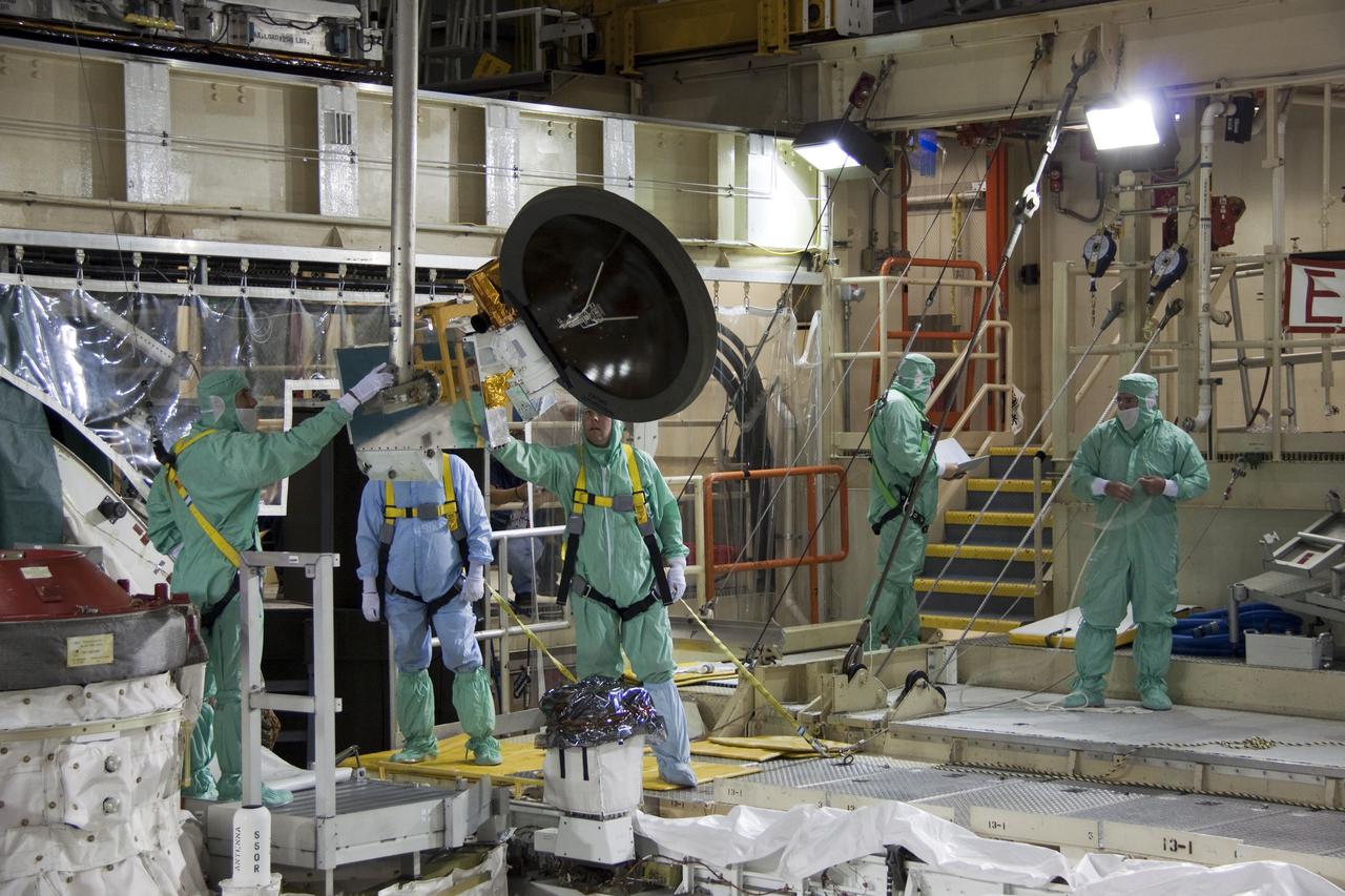 CAPE CANAVERAL, Fla. -- Technicians install a new Ku-Band communications system antenna on space shuttle Discovery in Orbiter Processing Facility-3 at NASA's Kennedy Space Center in Florida. The antenna is used to transmit and receive high data rate communications, such as video, and is being replaced for the STS-133 mission to the International Space Station.  During its STS-131 mission to the station in April, Discovery's Ku-Band failed to operate in orbit. As a result, video of the thermal protection system inspection had to be recorded aboard Discovery and transmitted to the ground after the shuttle docked with the station. Typically, the inspection video is simultaneously transmitted live to the ground and recorded aboard the shuttle for later review. NASA_Charisse Nahser