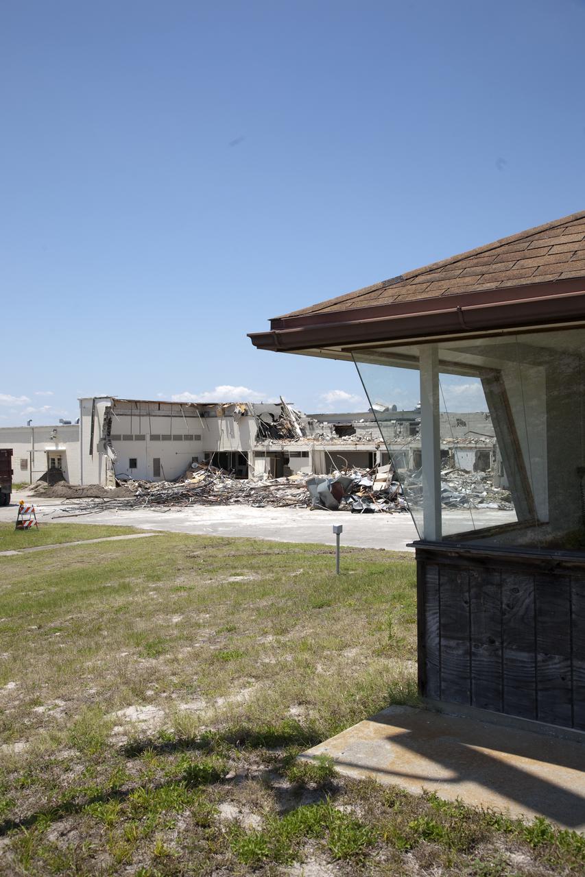 CAPE CANAVERAL, Fla. – At Cape Canaveral Air Force Station in Florida, demolition of the Mercury Mission Control Center has begun.  The original building, constructed between 1956 and 1958, was last modified in 1963.  The center succumbed to the two worst enemies of structures along the space coast - time and salt air - necessitating that it be demolished as a safety measure.  The facility served as mission control during all the Project Mercury missions, as well as the first three flights of the Gemini Program. The center housed the flight controllers whose duty was to take over flight control after liftoff and follow it through until splashdown. Additionally, it supported vehicle checkout, spacecraft tracking, and astronaut training. With Gemini IV, mission control moved to Houston, and the facility took on the roles of launch control and tracking station. In 1999, much of the equipment and furnishings from the flight control area was moved to Kennedy Space Center's Visitor Complex.  A re-created mission control room currently is on display in the complex's Dr. Kurt H. Debus Conference Facility.  Speegle II of Cocoa, Fla., was awarded the contract for the deconstruction project.  Frank-Lin Excavating is performing the demolition for Sunrise Systems of Brevard, a subcontractor to Speegle II.  Photo credit: NASA_Dimitri Gerondidakis
