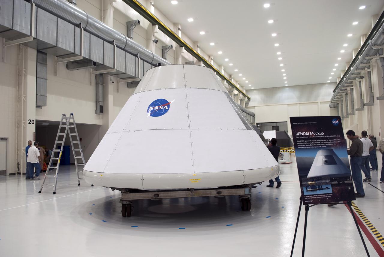 CAPE CANAVERAL, Fla. – In the Operations and Checkout Building at NASA's Kennedy Space Center in Florida, Joint Extravehicular NBL ORION Mockup, or JENOM, is on display. The mock-up details the interior components of the vehicle including seat layout and the subsystem components on the outside of the pressure vessel. Orion mock-ups also have been used to verify accessibility of the servicing locations at the launch pad and in the Vehicle Assembly Building. For information on the development of the Orion capsule, visit www.nasa.gov_orion. Photo credit: NASA_Jim Grossmann