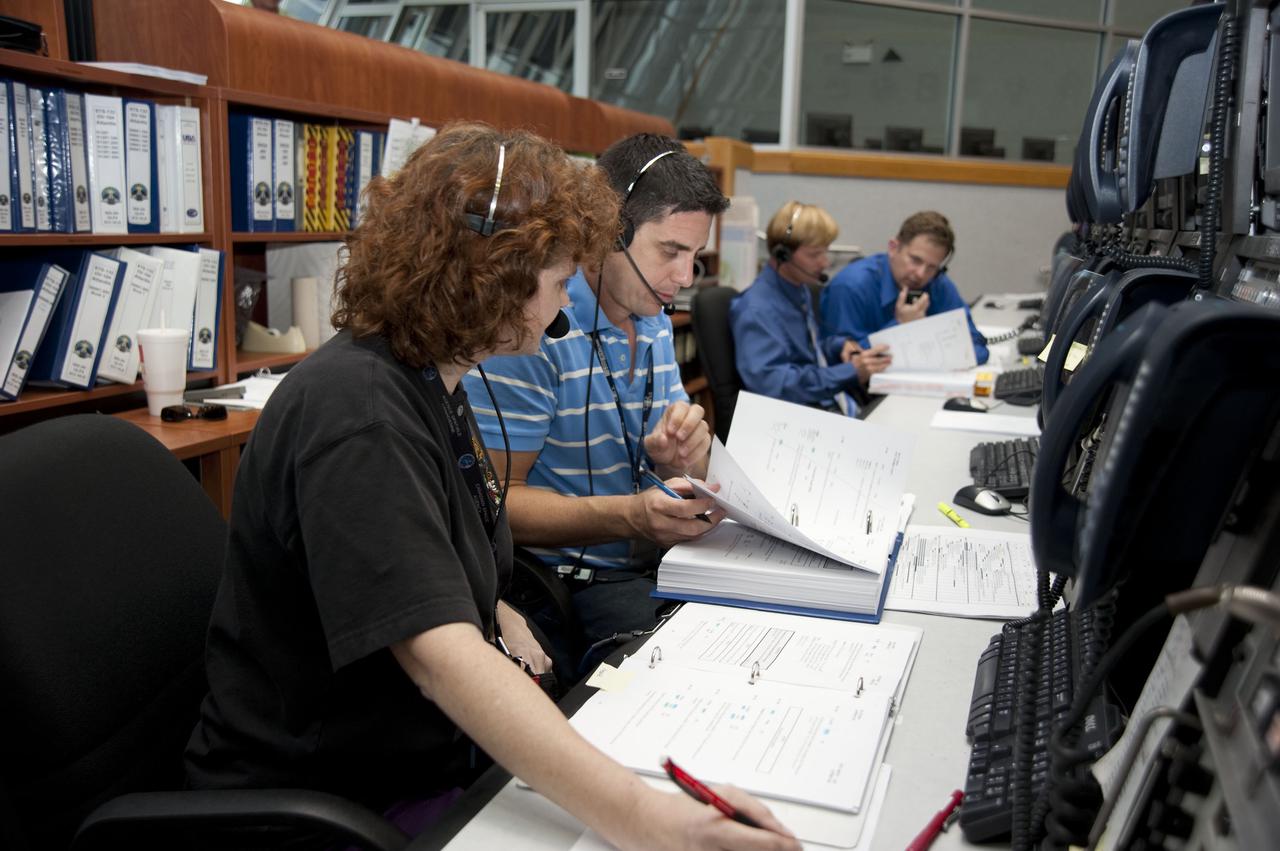CAPE CANAVERAL, Fla. – At NASA's Kennedy Space Center in Florida, members of the STS-132 launch team take their stations in Firing Room 4 for the start of the countdown to launch of space shuttle Atlantis' STS-132 mission.  From left are United Space Alliance Orbiter Test Conductors Lauren Sally and Scott Kraftchick and NASA Test Directors William Heidtman and Jeffrey Skaja.  The clocks in Kennedy’s Launch Control Center started ticking backward at 4 p.m. EDT at the T-43 hour mark.  Launch is targeted for 2:20 p.m. on May 14.  On the STS-132 mission, the six-member crew will deliver an Integrated Cargo Carrier, or ICC, and the Russian-built Mini-Research Module-1, or MRM-1, to the International Space Station.  The ICC is an unpressurized flat bed pallet and keel yoke assembly used to support the transfer of exterior cargo from the shuttle to the space station.  The MRM-1, known as Rassvet, is the second in a series of new pressurized components for Russia and will be permanently attached to the Earth-facing port of the Zarya control module. Rassvet, which translates to 'dawn,' will be used for cargo storage and will provide an additional docking port to the station.  STS-132 is the 34th mission to the station and the 132nd shuttle mission overall.  For information on the STS-132 mission, visit http:__www.nasa.gov_mission_pages_shuttle_shuttlemissions_sts132_index.html. Photo credit: NASA_Kim Shiflett