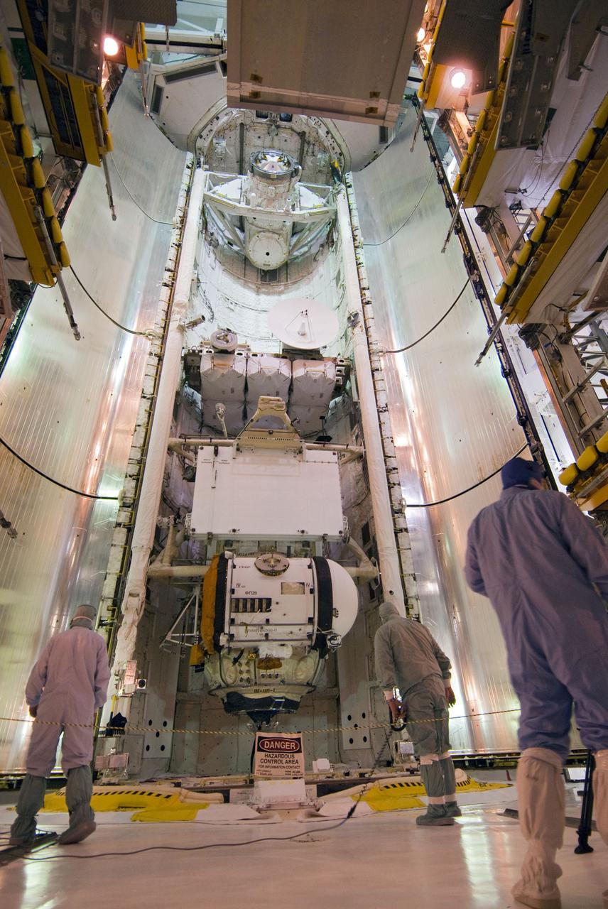 CAPE CANAVERAL, Fla. - At Launch Pad 39A at NASA's Kennedy Space Center in Florida, technicians prepare to close space shuttle Atlantis' payload bay doors for launch to the International Space Station. Secured in the bay is the primary payload for Atlantis' STS-132 mission, the Russian-built Mini Research Module-1. A set of batteries for the station's truss and space-to-ground antenna, along with other replacement parts are installed on the Integrated Cargo Carrier. Atlantis' launch is targeted for May 14 at 2:20 p.m. EDT. For more information on the STS-132 mission objectives, payload and crew, visit www.nasa.gov_mission_pages_shuttle_shuttlemissions_sts132_index.html. Photo Credit: NASA_Cory Huston
