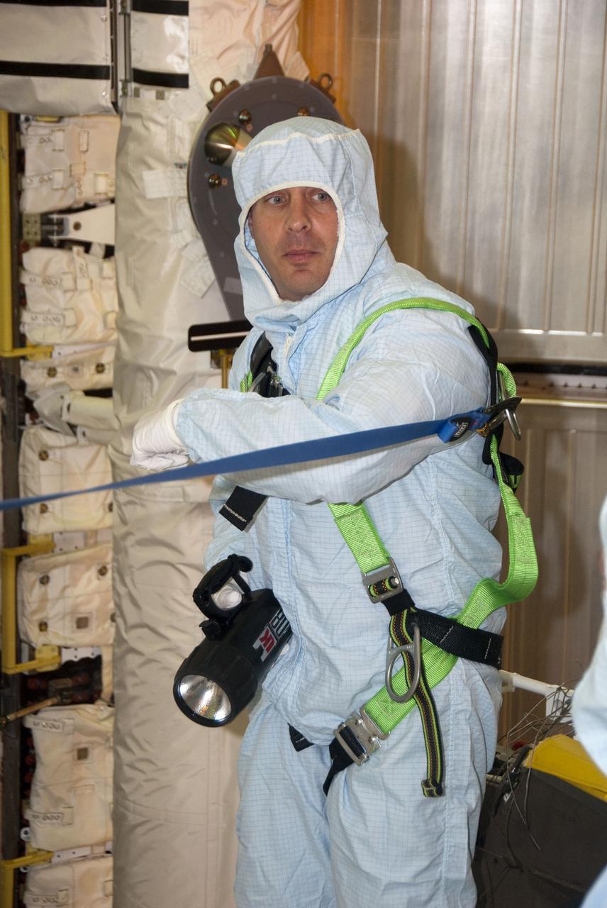 CAPE CANAVERAL, Fla. - At Launch Pad 39A at NASA's Kennedy Space Center in Florida, STS-132 Mission Specialist Garrett Reisman gets a close view of the cargo being delivered to the International Space Station on his mission before space shuttle Atlantis' payload bay doors are closed for flight.  On the STS-132 mission, the six-member crew will deliver an Integrated Cargo Carrier, or ICC, and the Russian-built Mini-Research Module-1, or MRM-1, to the International Space Station.  The ICC is an unpressurized flat bed pallet and keel yoke assembly used to support the transfer of exterior cargo from the shuttle to the space station.  The MRM-1, known as Rassvet, is the second in a series of new pressurized components for Russia and will be permanently attached to the Earth-facing port of the Zarya control module. Rassvet, which translates to 'dawn,' will be used for cargo storage and will provide an additional docking port to the station.  STS-132 is the 34th mission to the station and the 132nd shuttle mission overall. Atlantis' launch is targeted for 2:20 p.m. EDT on May 14. For more information on the STS-132 mission objectives, payload and crew, visit www.nasa.gov_mission_pages_shuttle_shuttlemissions_sts132_index.html. Photo Credit: NASA_Cory Huston